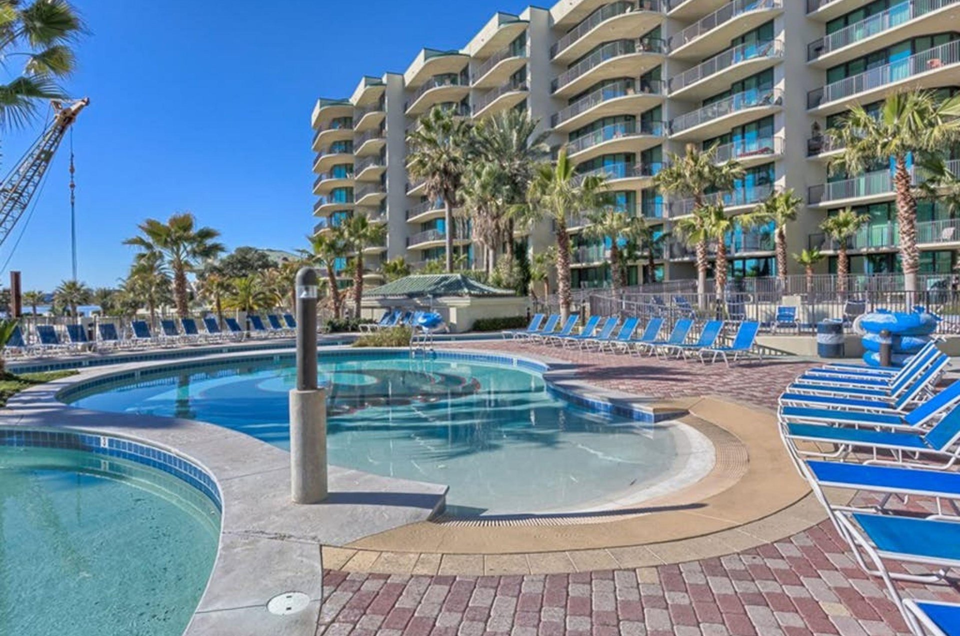 Lounge chairs by the outdoor pool in front of Phoenix on the Bay in Orange Beach Alabama