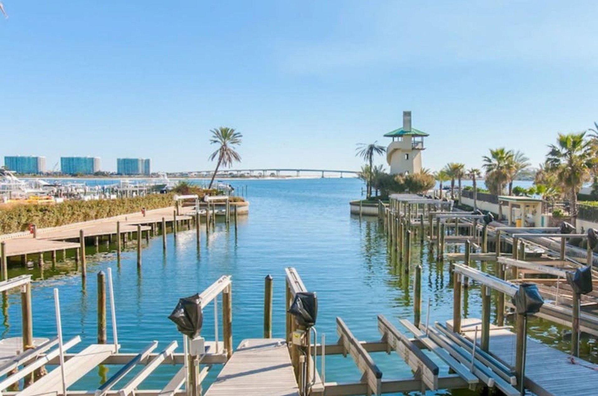 A wooden dock with boat slips on the bay at Phoenix on the Bay in Orange Beach Alabama