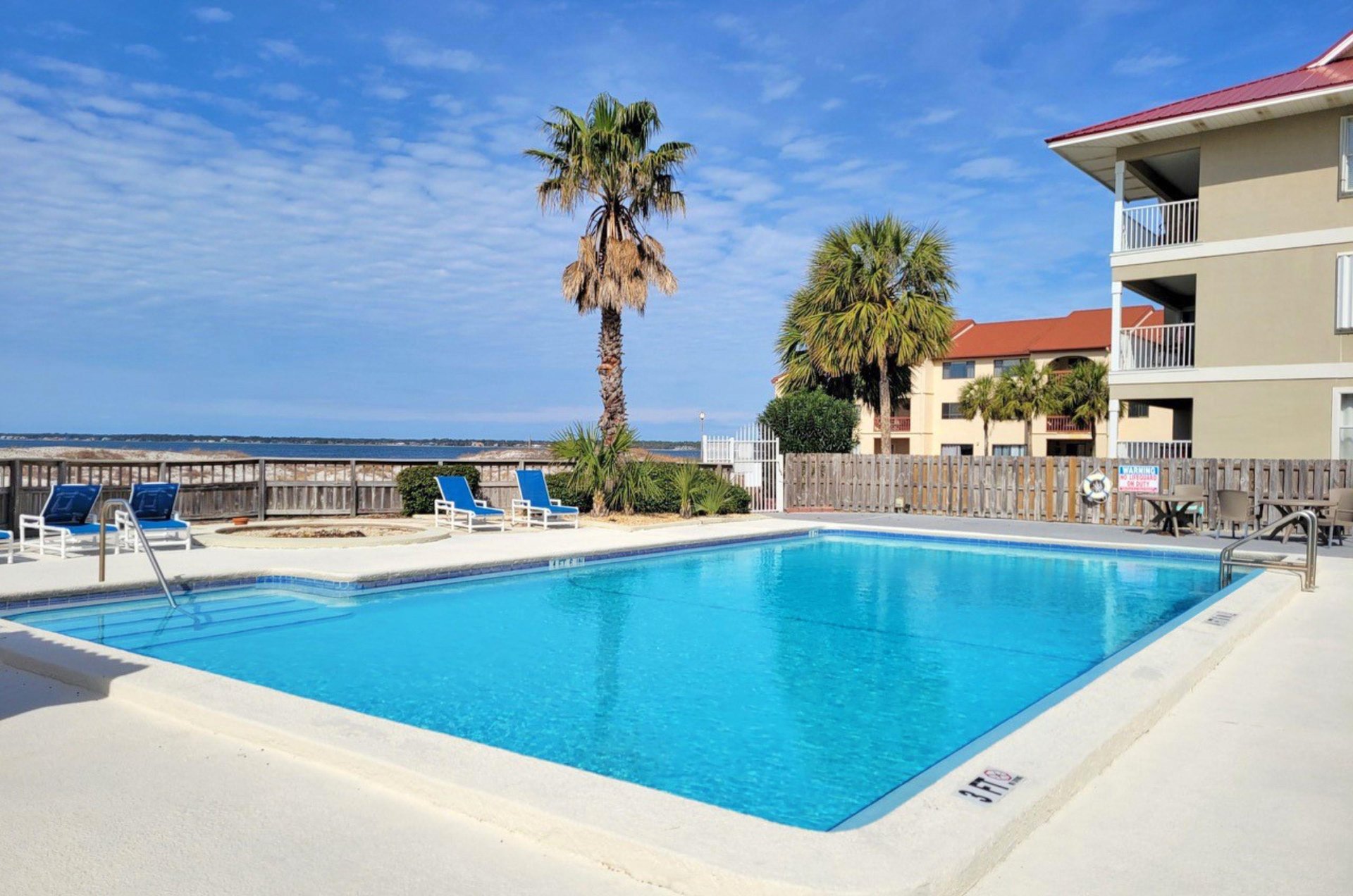 Lounge by the outdoor pool at Sunset Harbor Palms