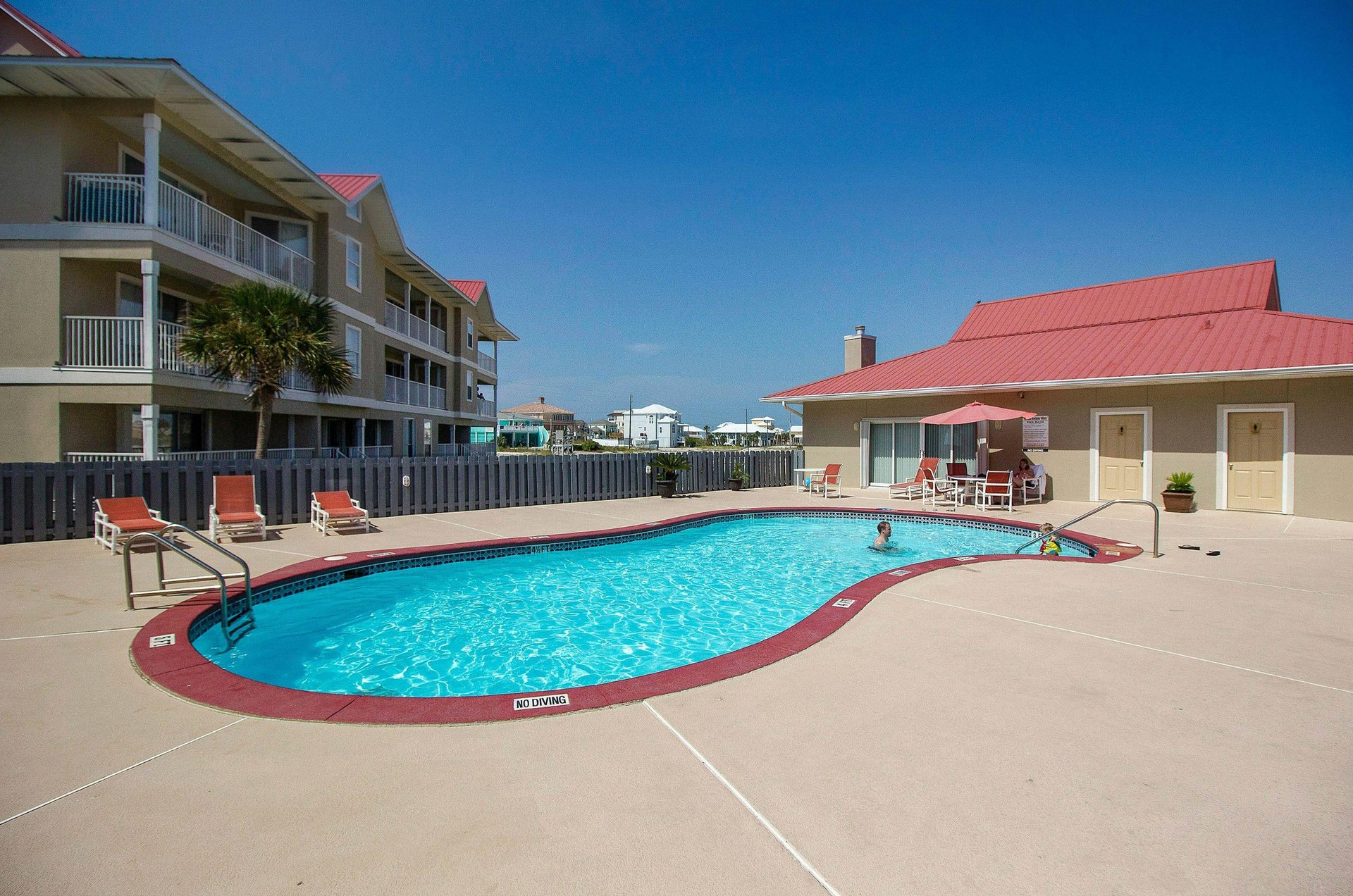 Soak up some sun by the pool at Sunset Harbor Villas