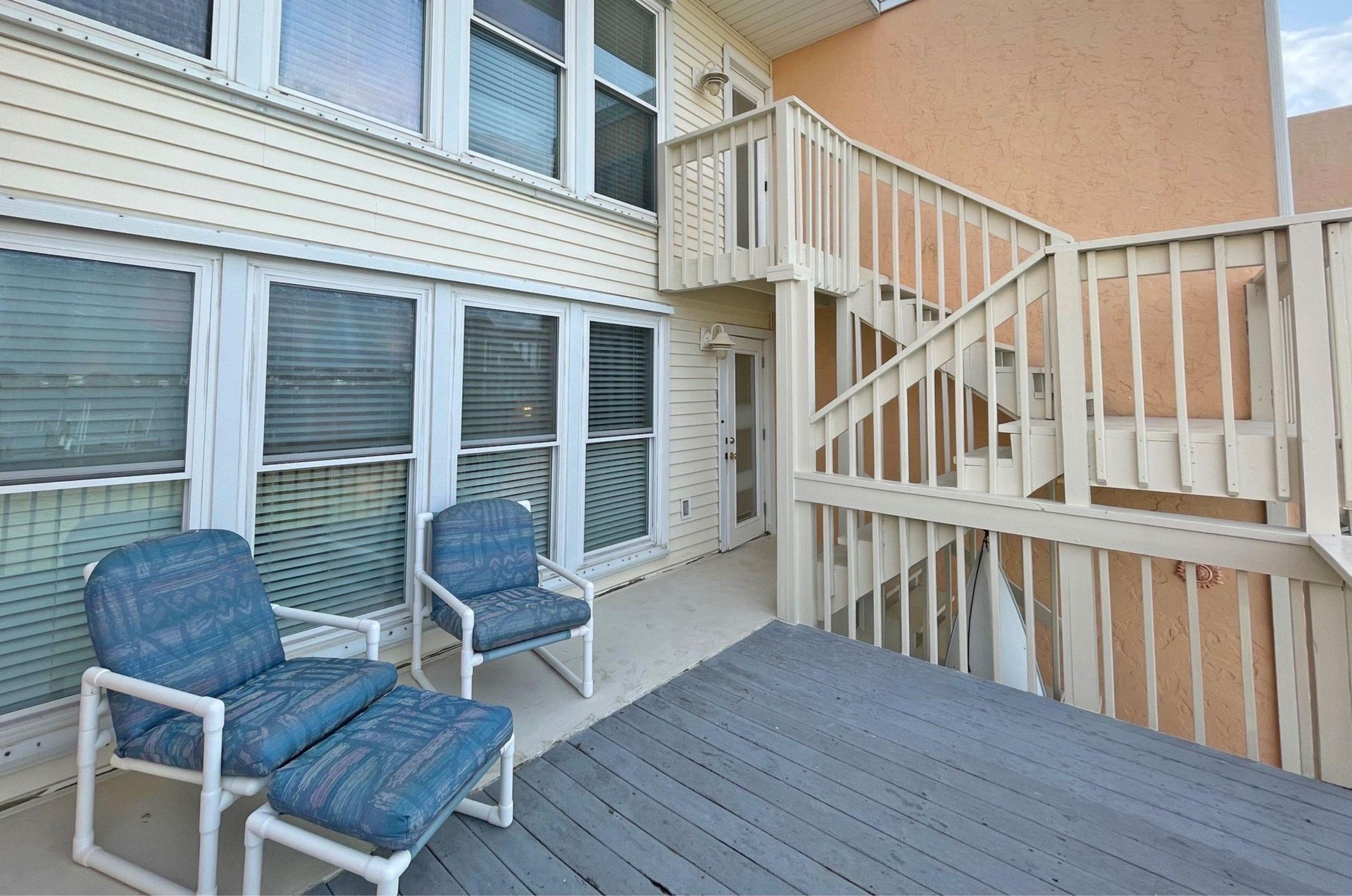 A private balcony with two lounge chairs and a table