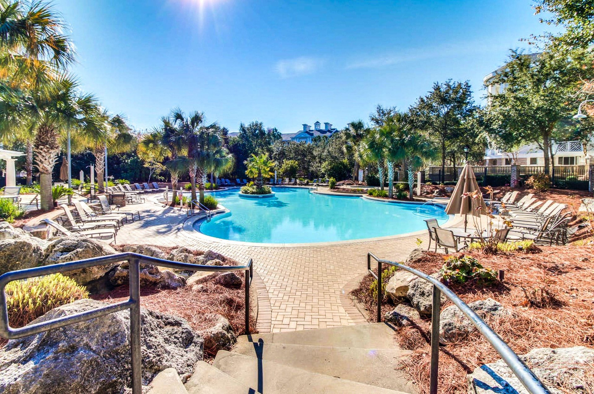 The swimming pool looks like a tropical oasis.