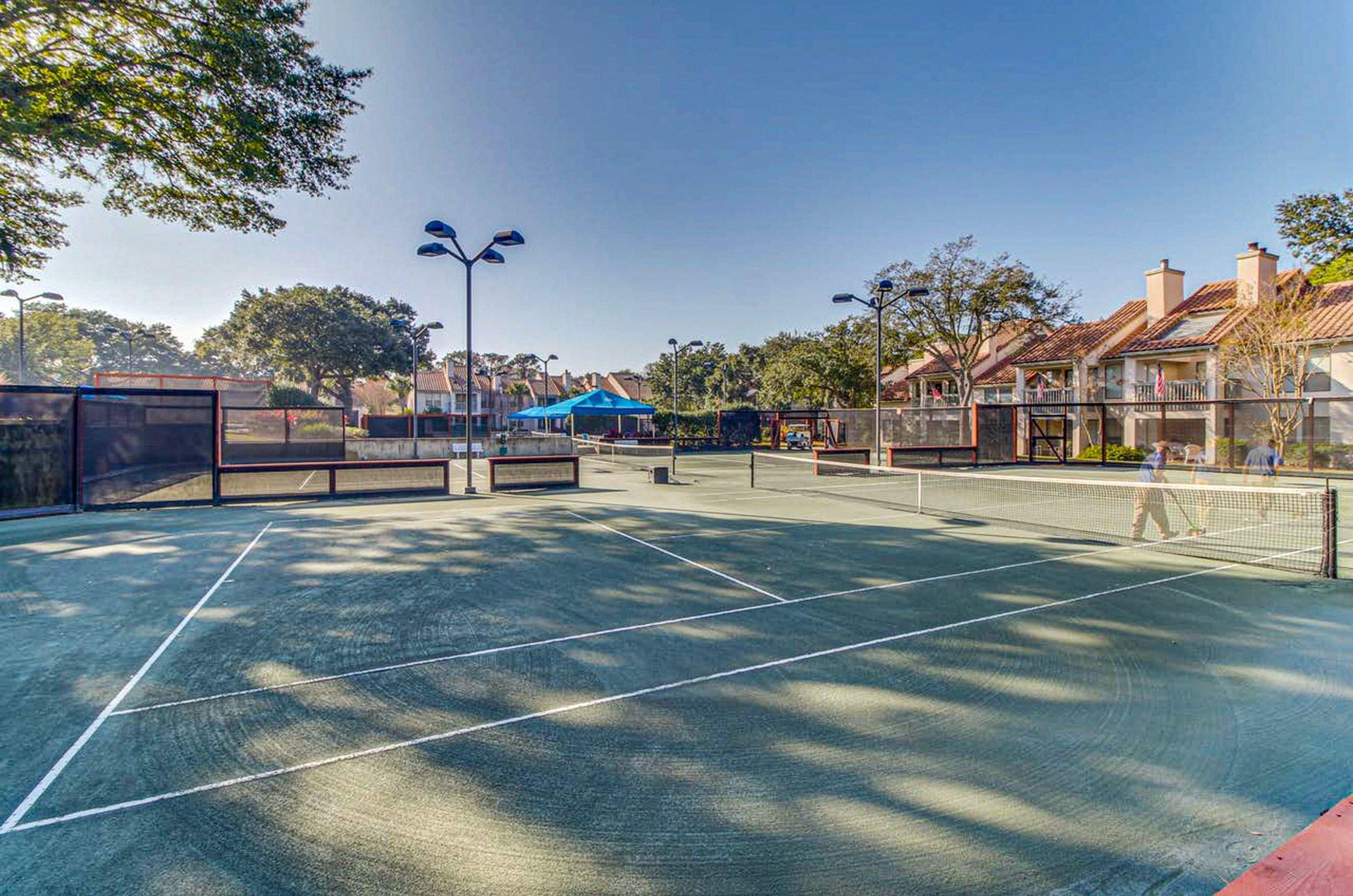 Tennis courts with lighting ready for daytime and nighttime play.