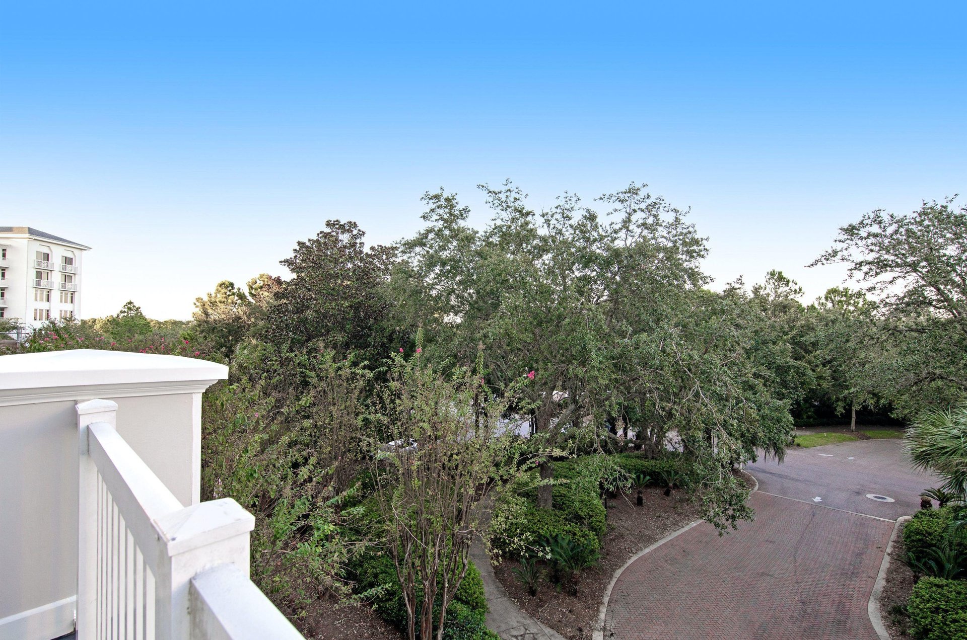 The property is filled with tropical landscaping.