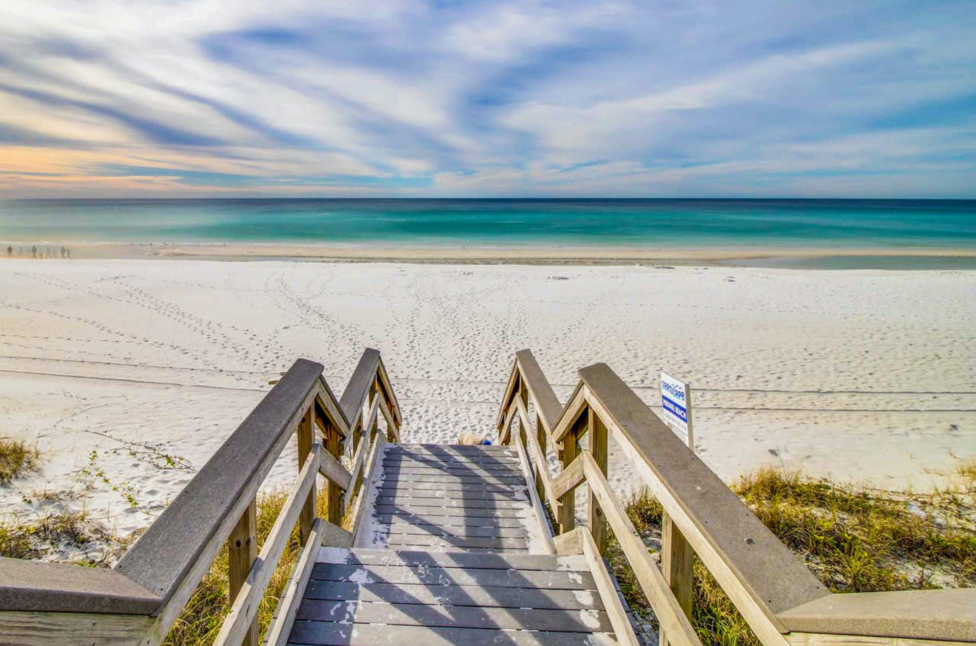 A Sandestin boardwalk leads to the ivorywhite and turquoiseblue beach.