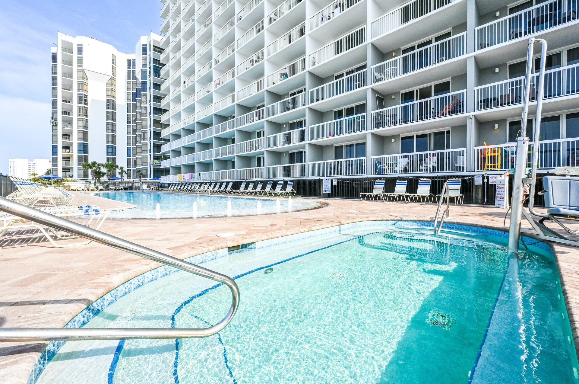 Balconies look out over shimmering community pools