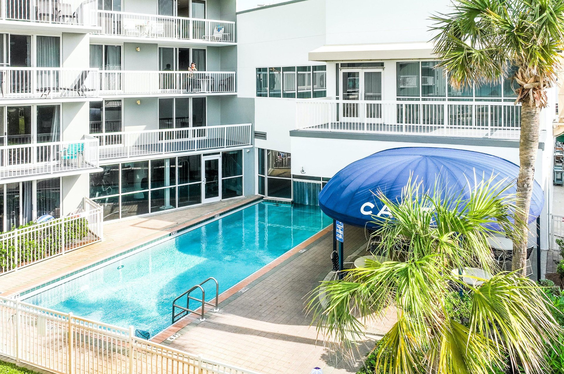 Balconies with views of an indooroutdoor pool