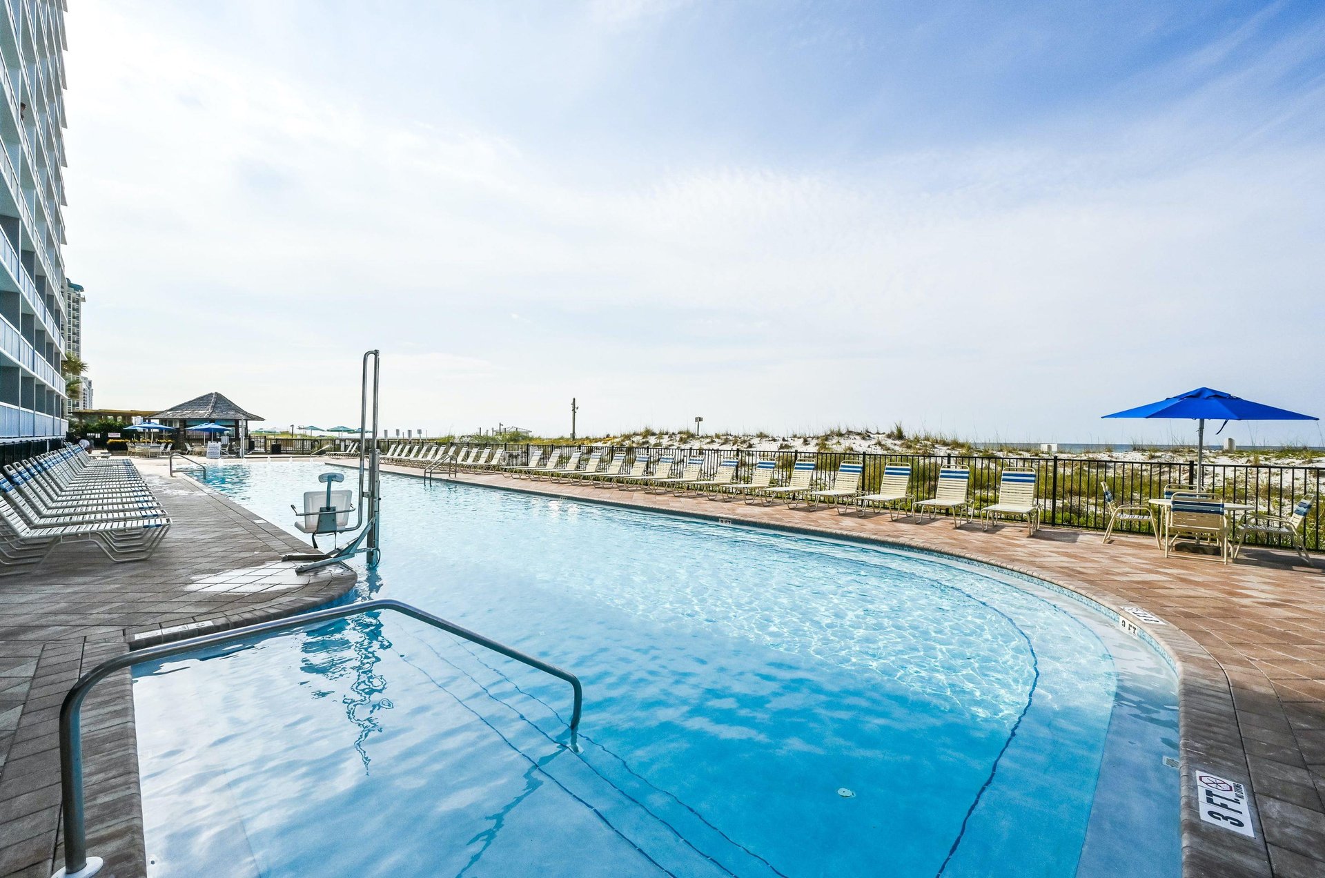 This community pool has a lift chair to assist guests getting into and out of the water