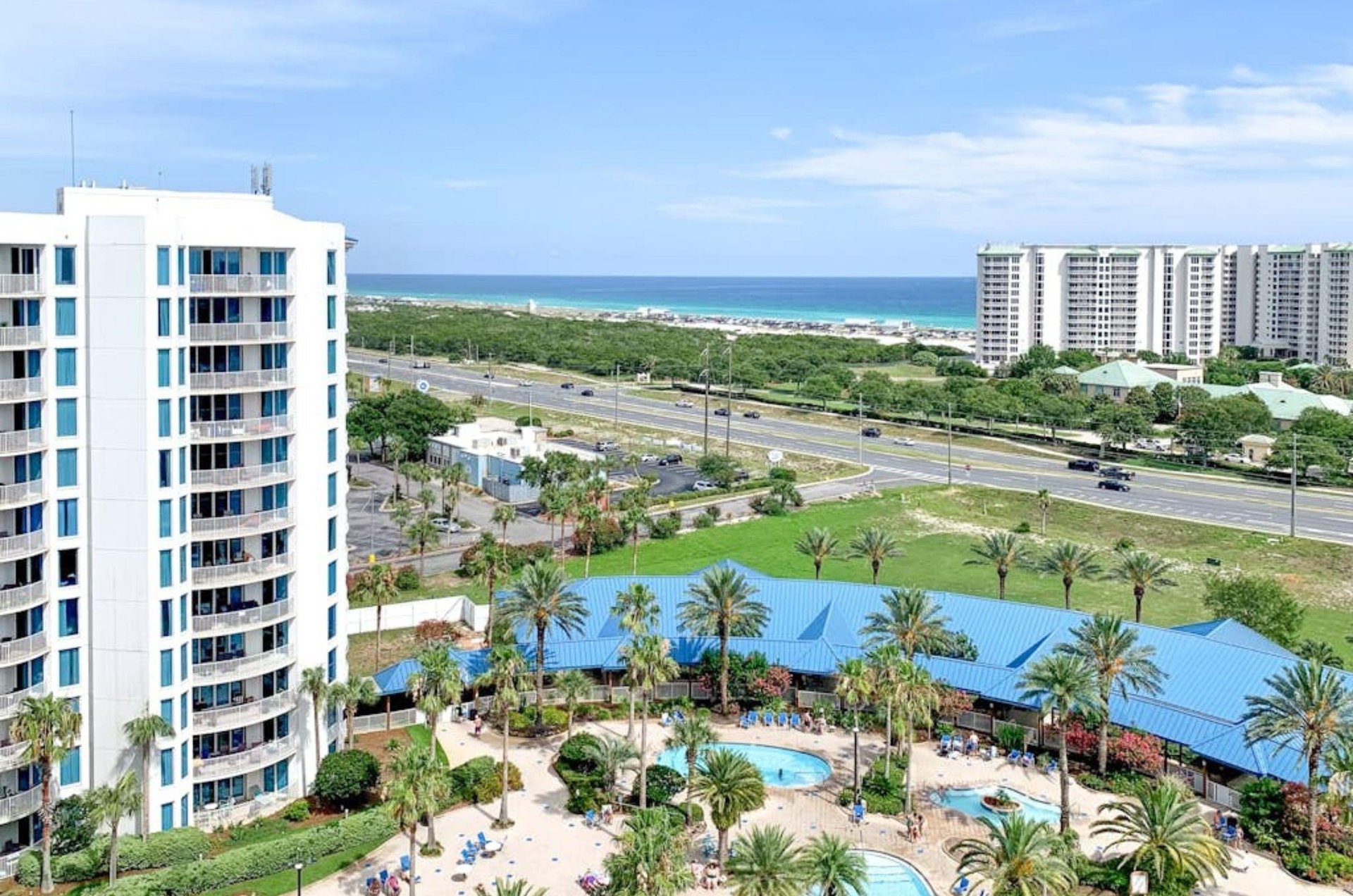 View from a balcony of the pool area and the street that separates the Palms of Destin from the Gulf of Mexico