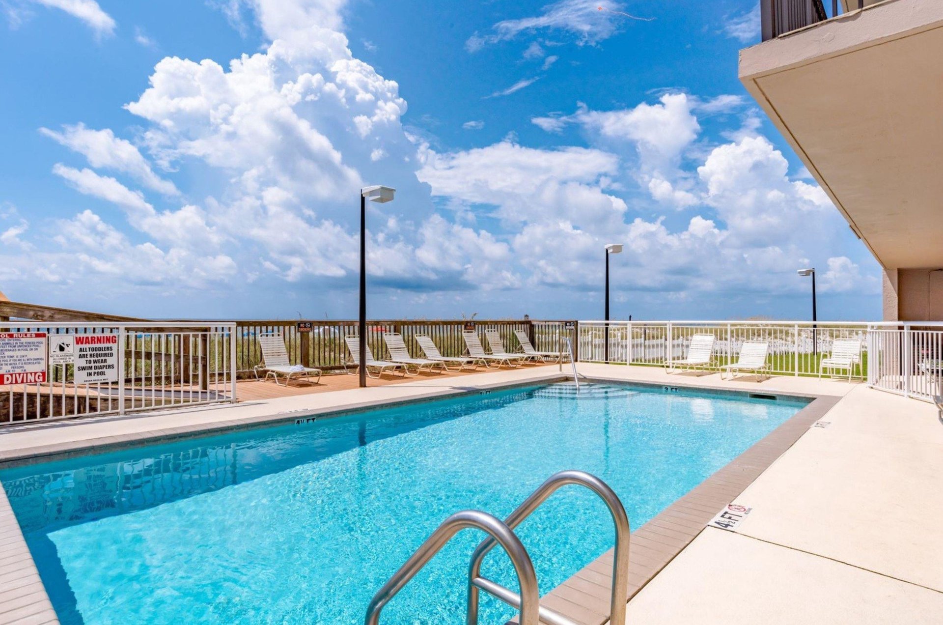 The beachside outdoor swimming pool at Ocean Breeze East Condos in Perdido Key Florida