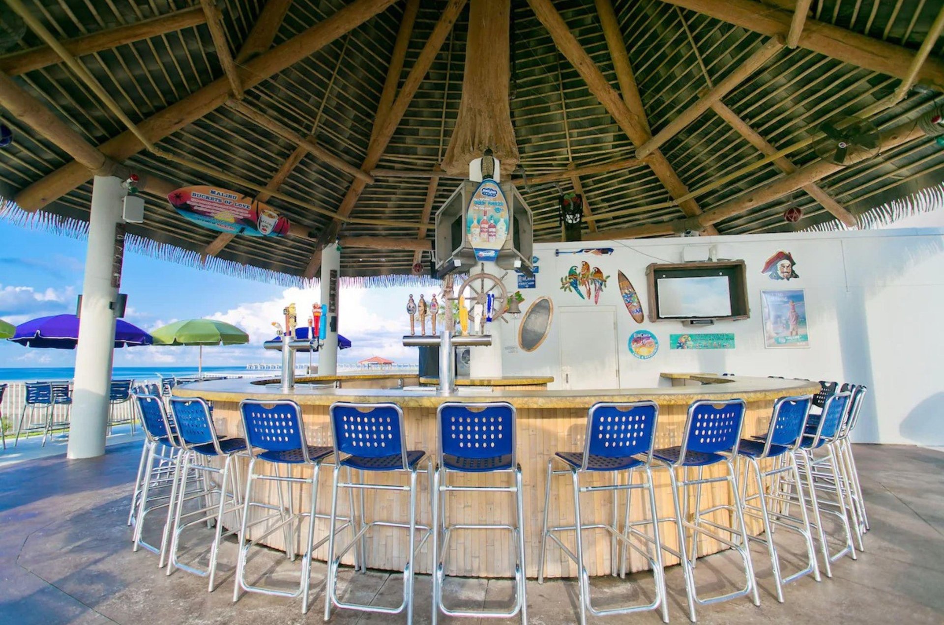 Grab a tropical drink from the poolside tiki hut bar