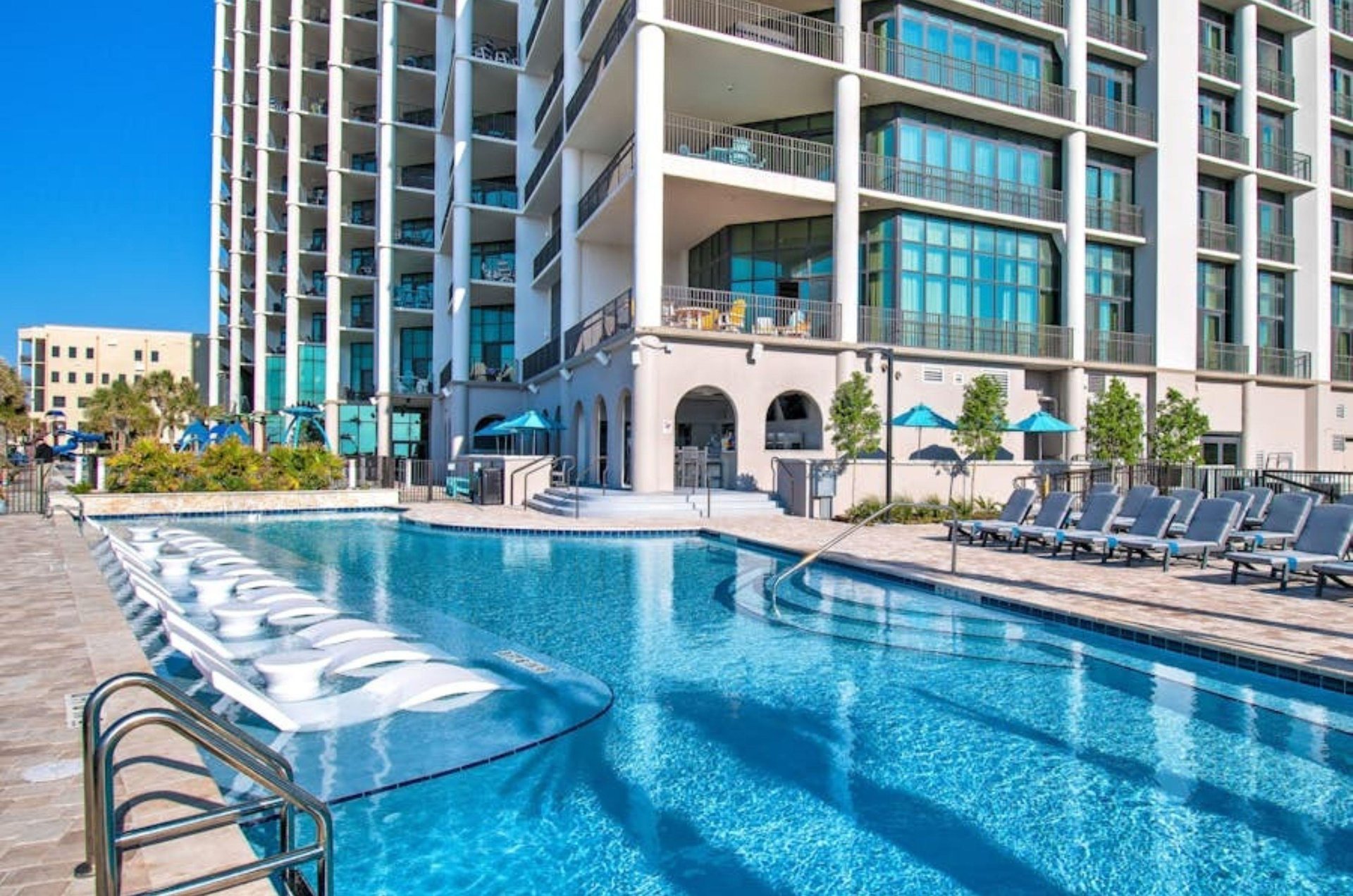 Lounge chairs in the shallow end of the swimming pool at Phoenix West II