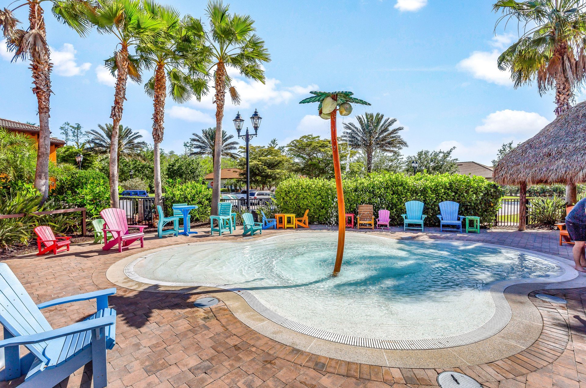 This community has a concrete wading pond with a palm tree fountain surrounded by a large sundeck and plenty of seating.
