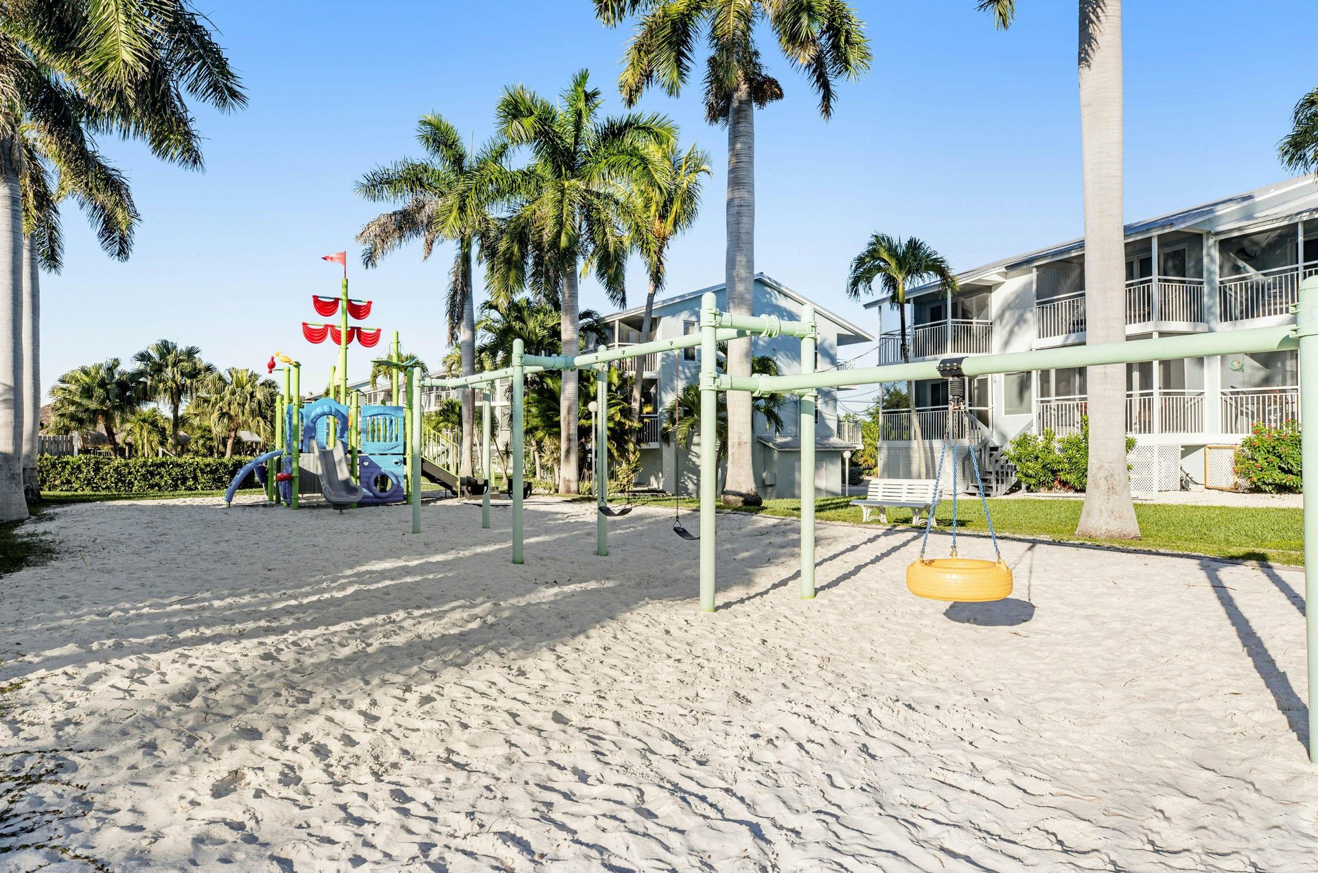 This sandy playground in a condo community stands ready for kids and adults to have fun.