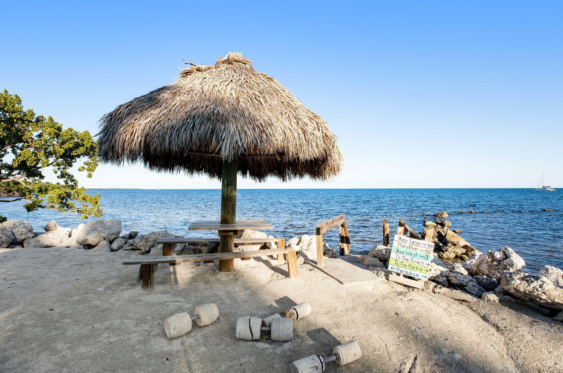 This picnic table under a thatched roof provides a great waterfront place to relax and share a picnic.