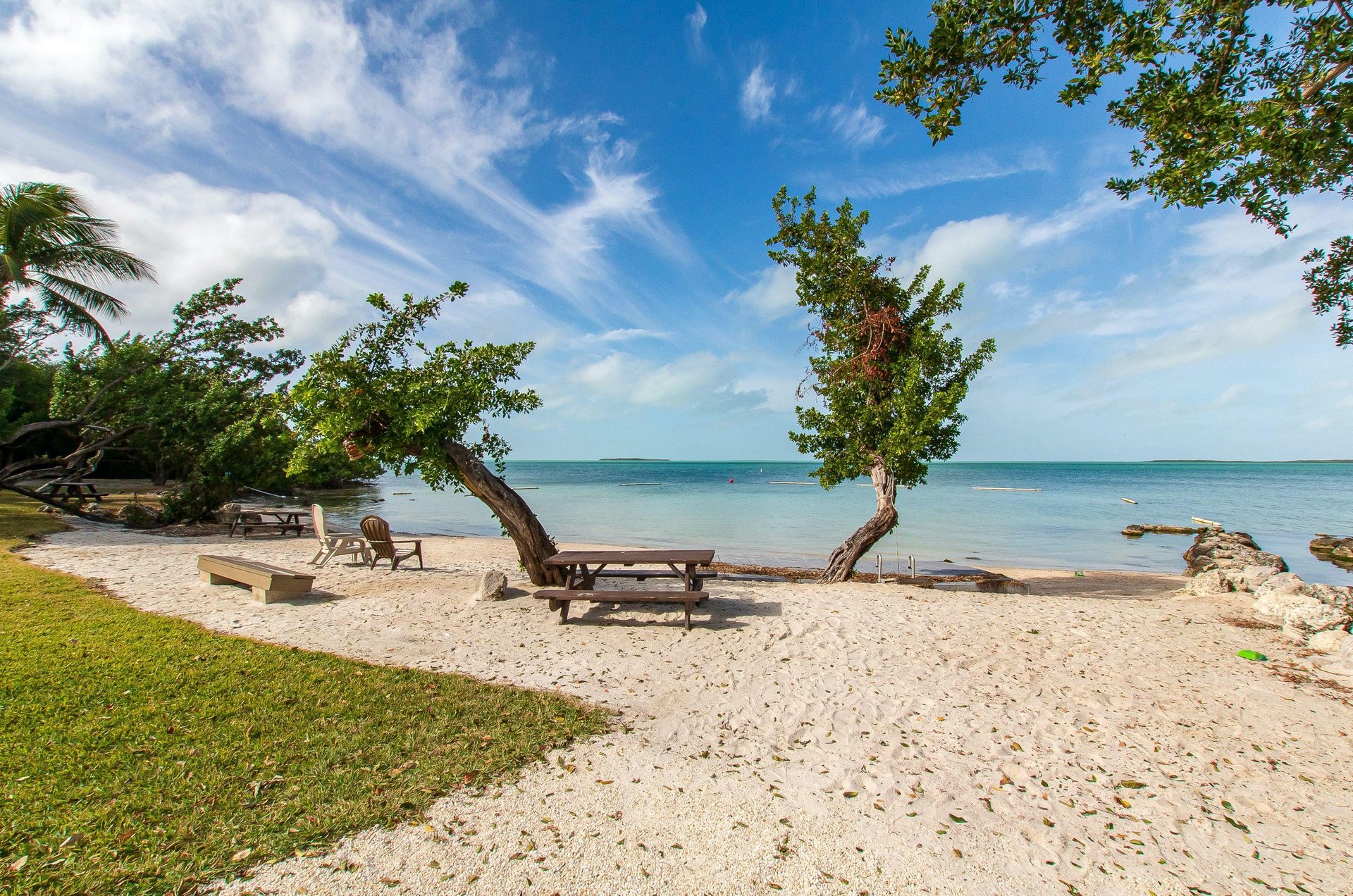 A sandy Key Largo beach looking out over the tranquil ocean waters.