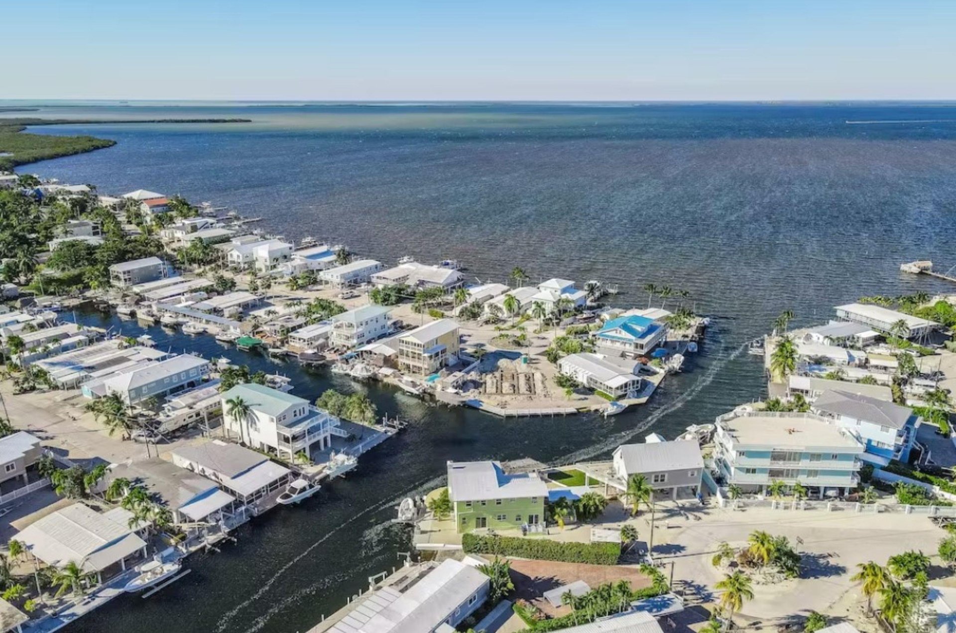 An aerial view of dozens of beautiful waterfront Key Largo vacation homes.