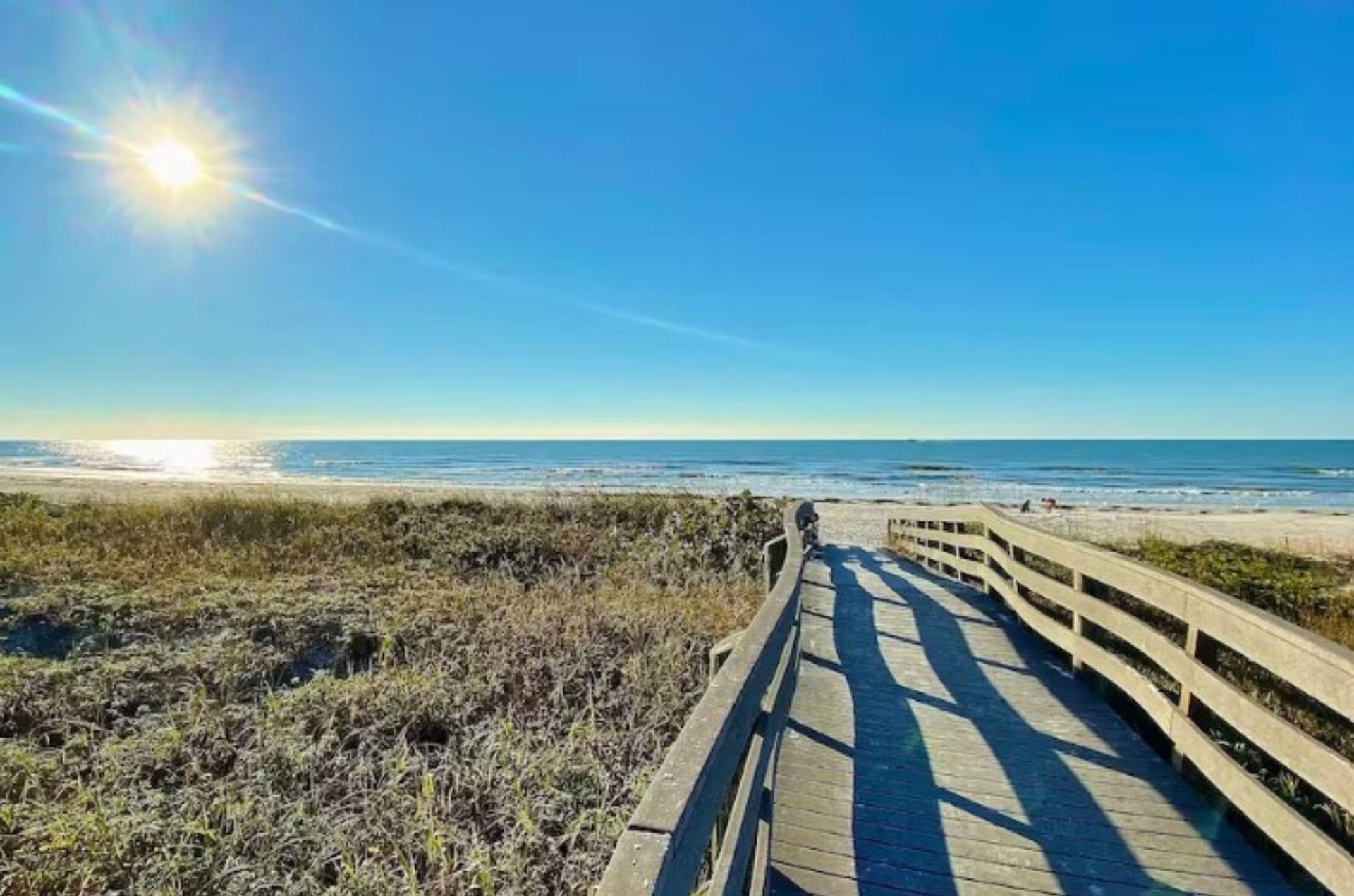 A boardwalk to one of Clearwaters beaches under sunny skies.