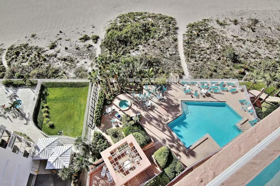 An aerial view of the resorts swimming pool, sundeck and beach access.