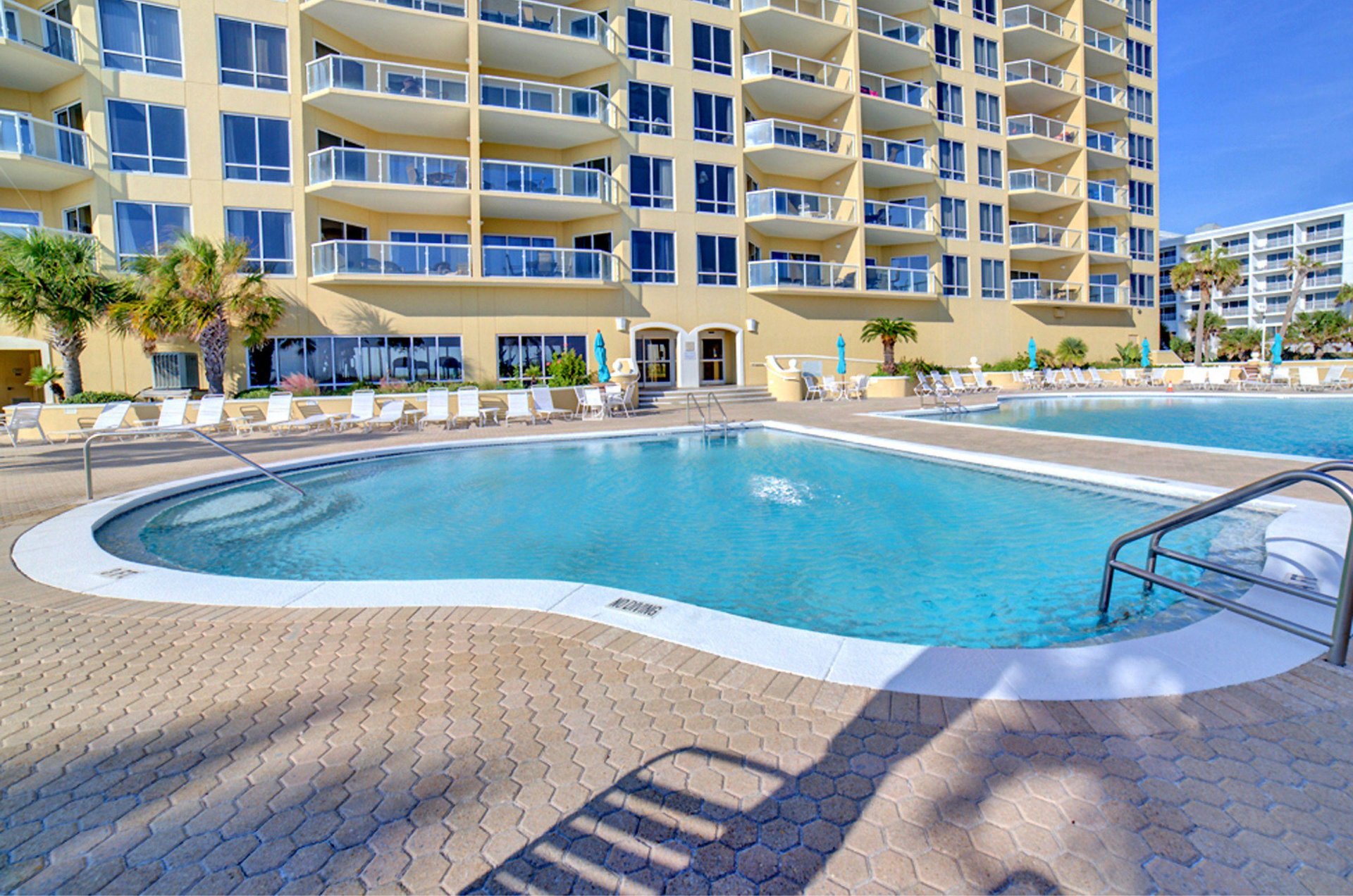 Amenities include two outdoor pools and a hot tub