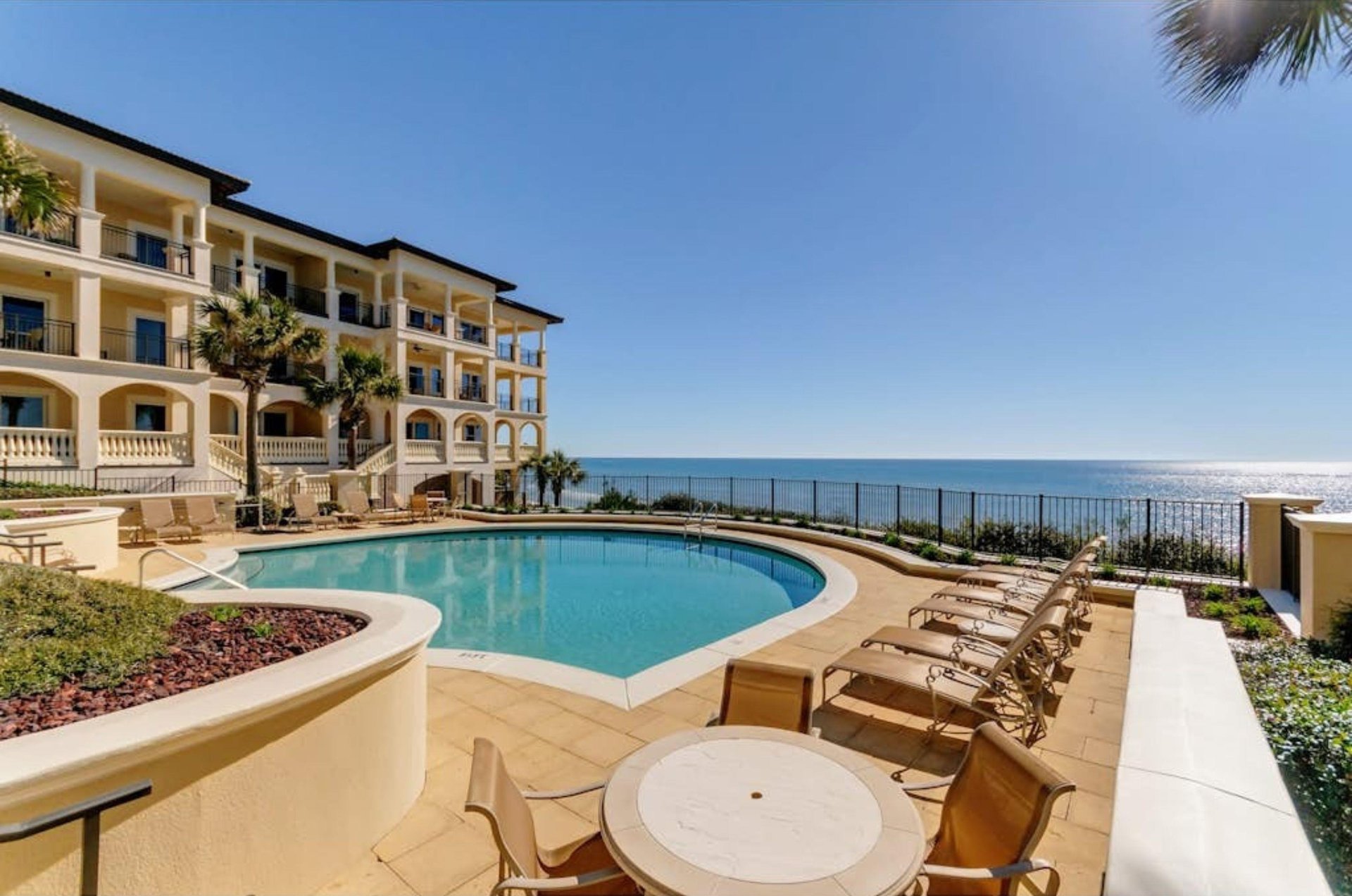 An outdoor pool and pool deck overlooking the Gulf at Bella Vita in Santa Rosa Beach Florida