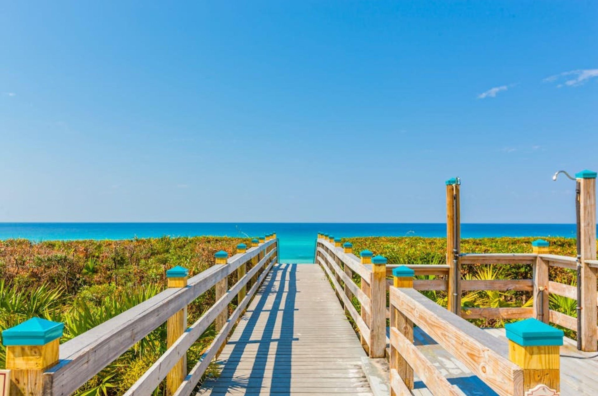 A wooden boardwalk leading to the Gulf of Mexico beaches across the street from the Village of South Walton