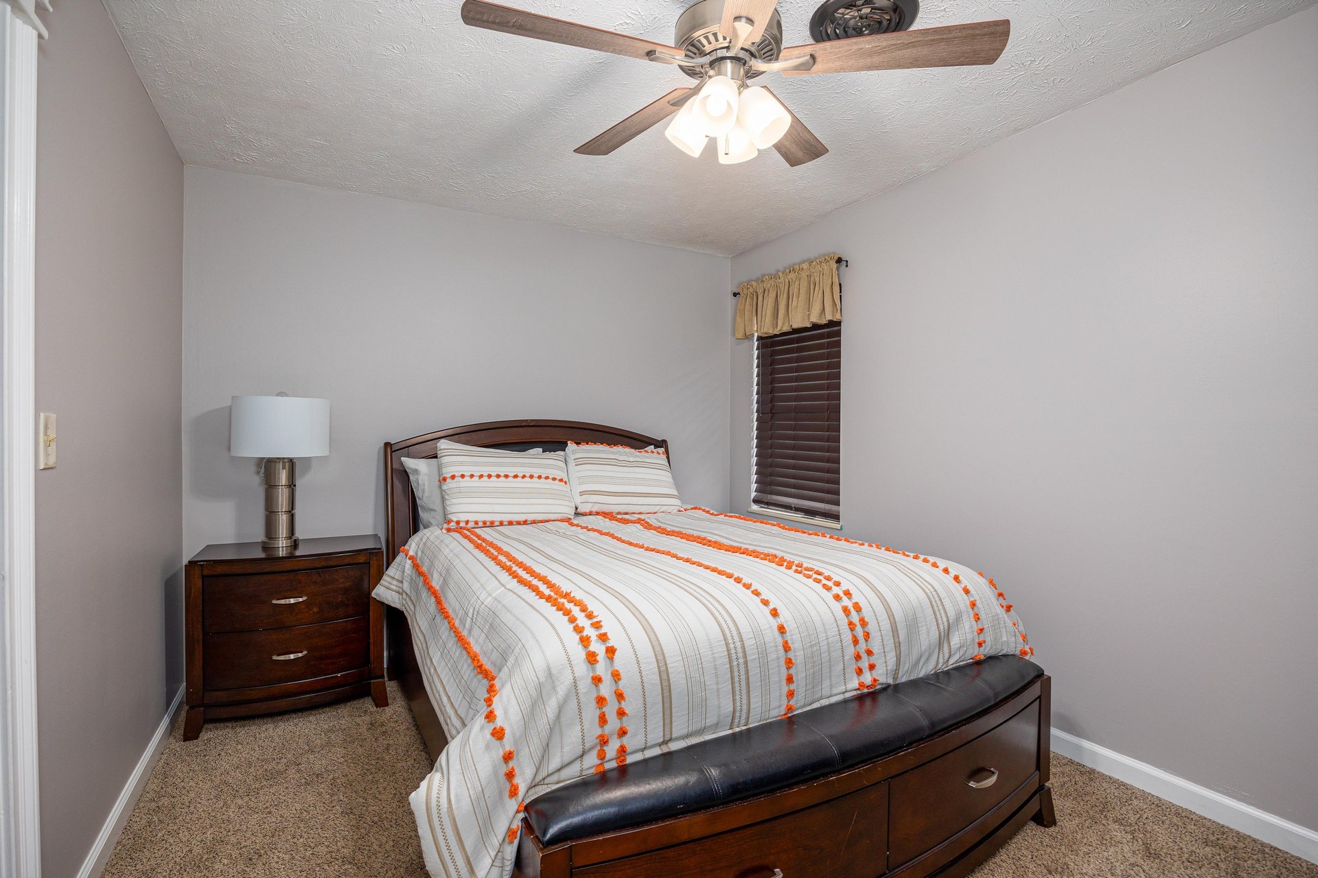 Bedroom With Bedside Table at Hoop Dreams Lodge