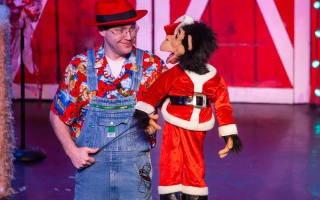 comedy barn christmas show with monkey puppet in santa suit