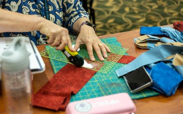 quilter cutting fabric at a mountain quiltfest in pigeon forge