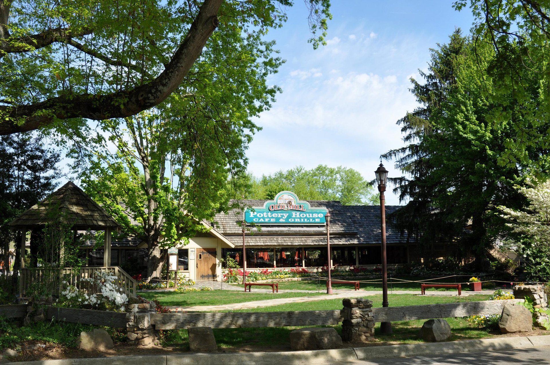 exterior of the old mill pottery house cafe surrounded by trees