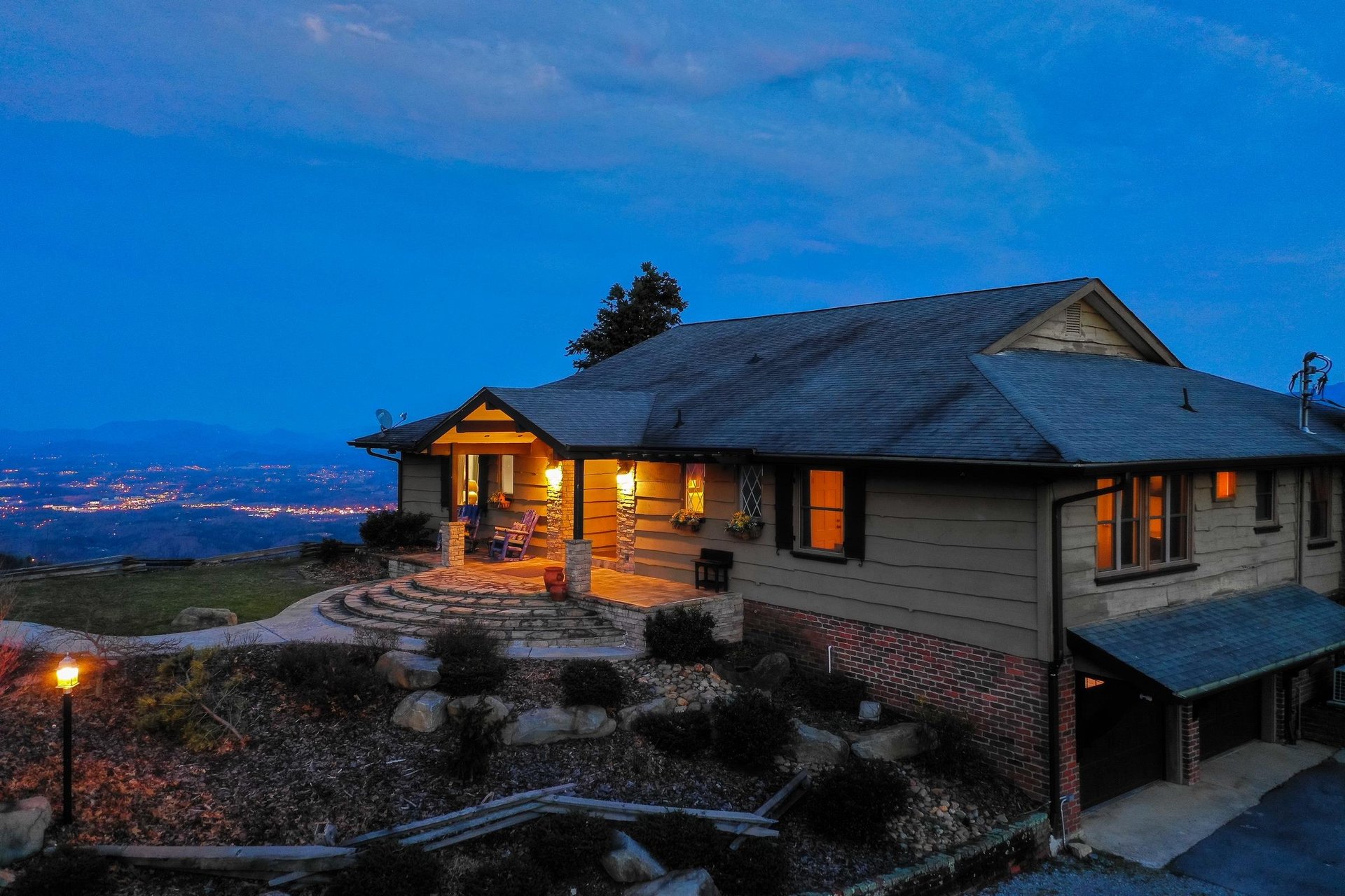 The cabin and city lights at twilight at Best View Ever A 5 bedroom cabin rental located in Pigeon Forge