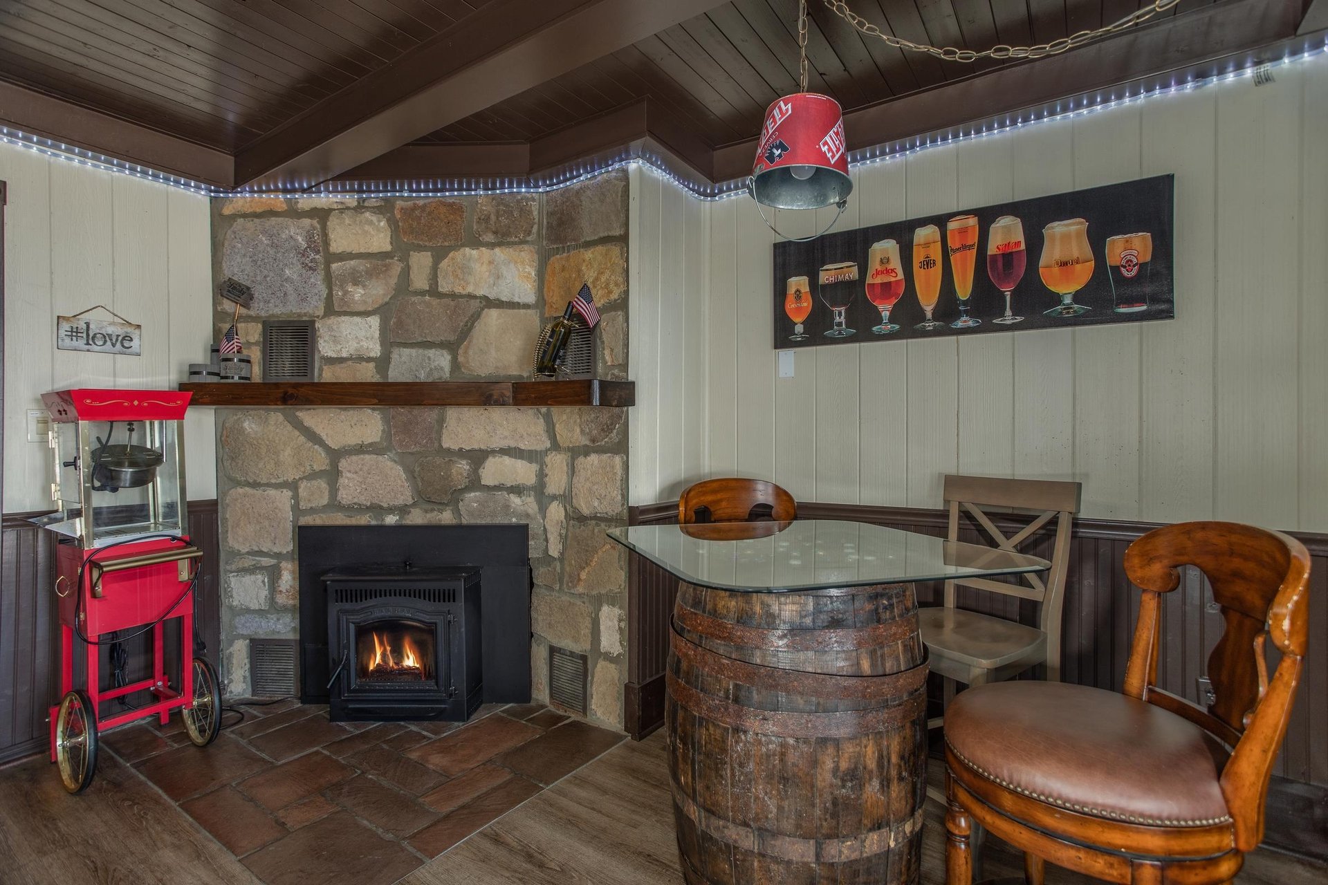 Fireplace, popcorn maker, and pub table on the lower floor at Best View Ever A 5 bedroom cabin rental in Pigeon Forge