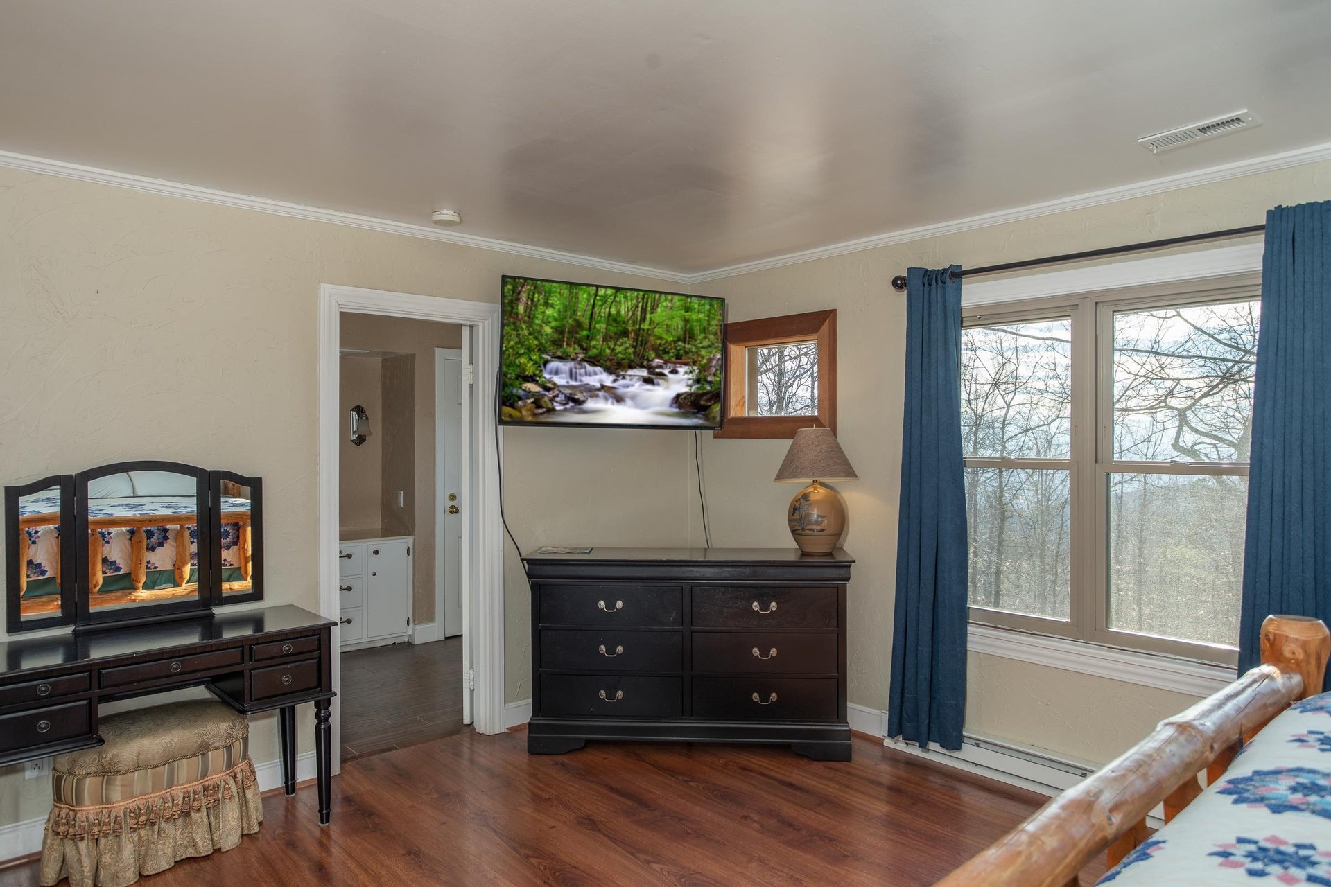 Dresser, TV, and vanity in a bedroom at Best View Ever A 5 bedroom cabin rental in Pigeon Forge