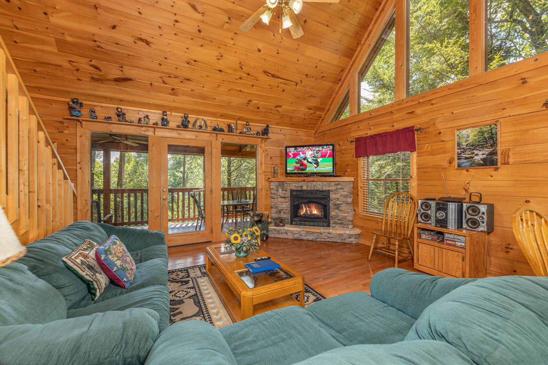 Living room with sofa, loveseat, fireplace, and TV at Cubs Crossing, a 3 bedroom cabin rental located in Gatlinburg