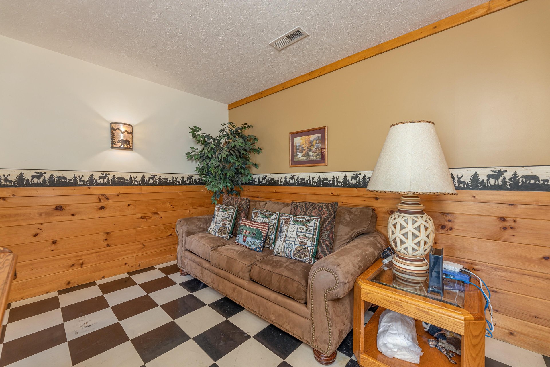 Sofa in the game room at Cubs Crossing, a 3 bedroom cabin rental located in Gatlinburg