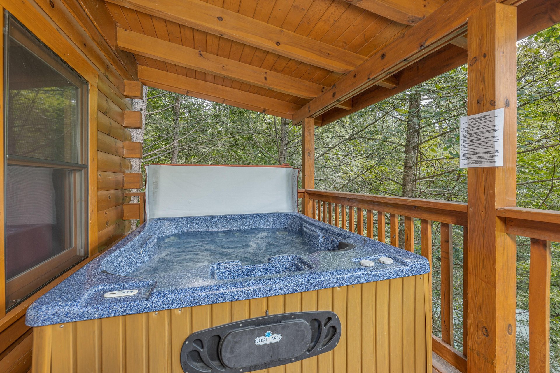 Hot tub on a covered deck at Cubs Crossing, a 3 bedroom cabin rental located in Gatlinburg