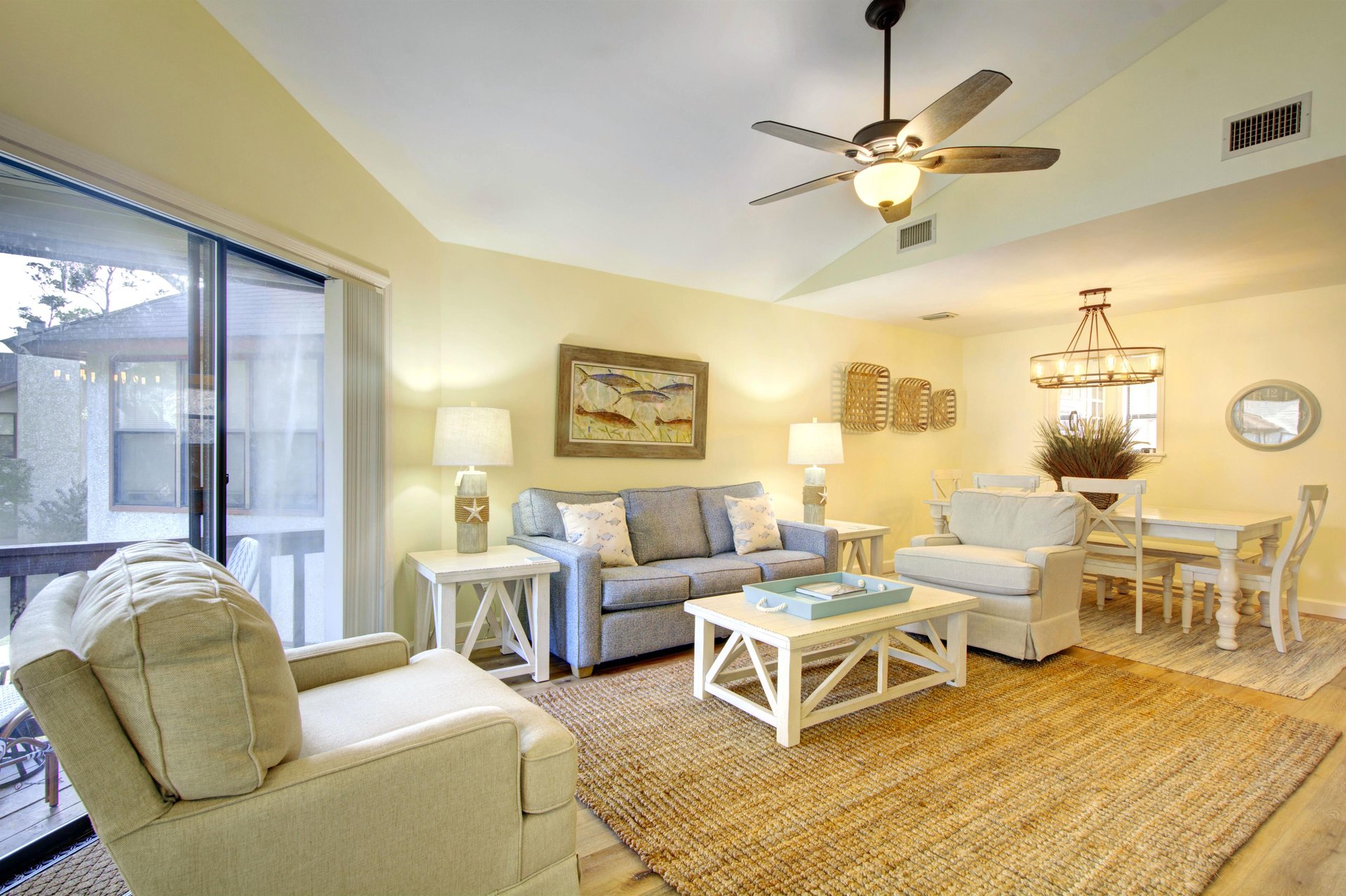 Bright, open living and dining space at 406 Harbour Oaks, perfect for relaxing after a beach day or walking back from dinner at Barbara Jeans.