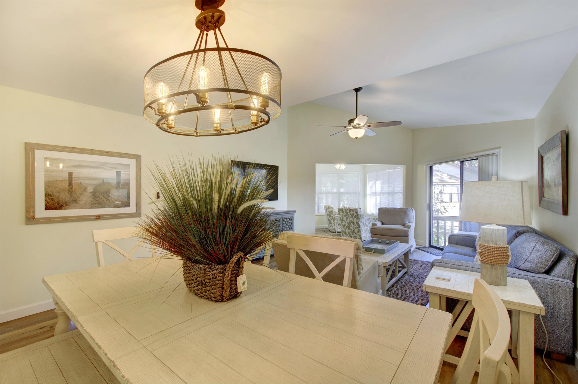 Gather for meals or game night in the coastalinspired dining area at 406 Harbour Oaks, with an open layout that connects seamlessly to the living room and screened porch.