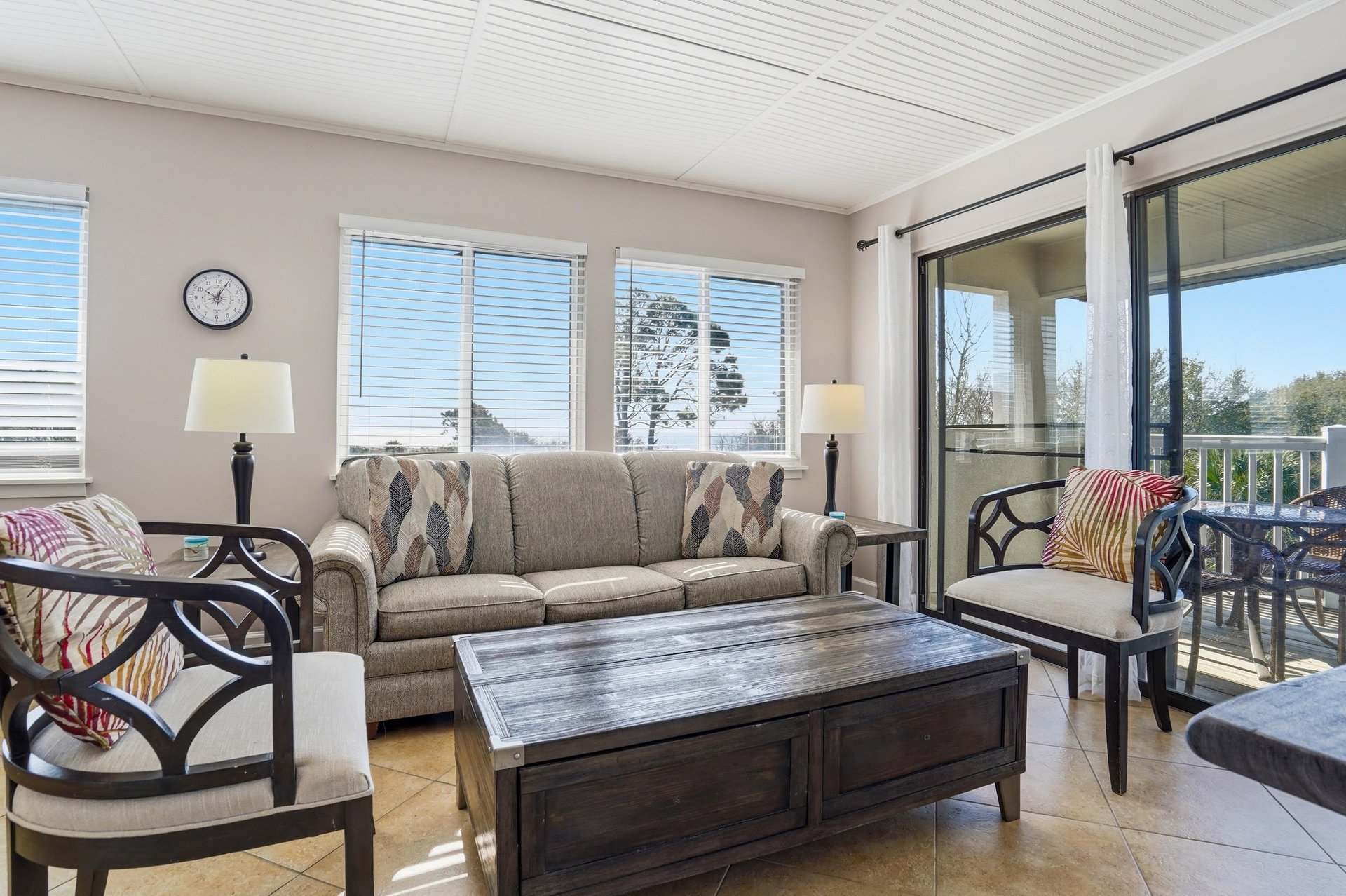 Comfortable seating and natural light create an easy flow between the indoor space and the outdoor balcony.