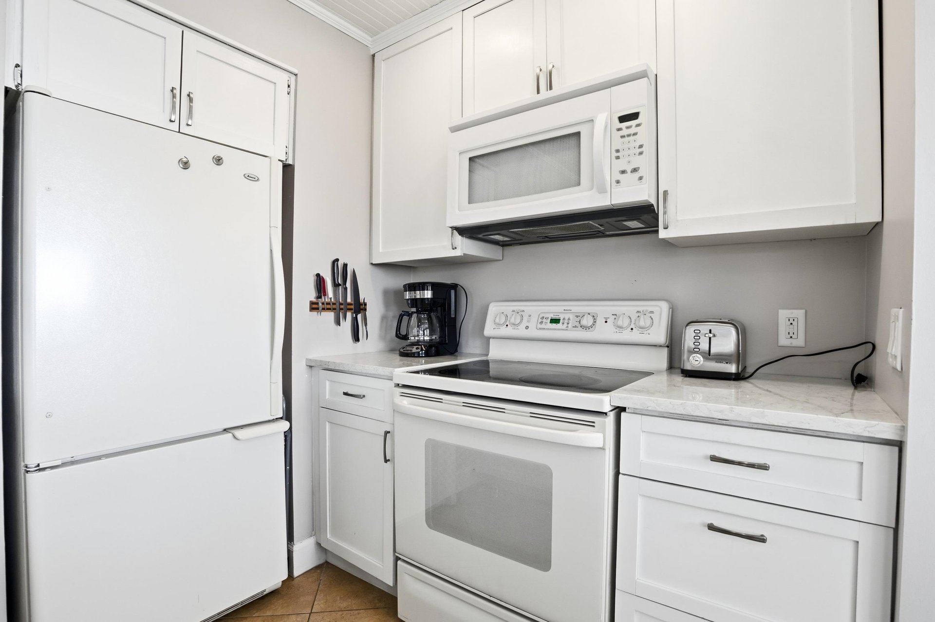 The kitchen features fullsize appliances and a clean, functional layout, perfect for easy meals during your stay.