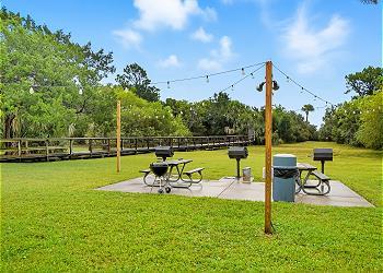 Enjoy a shaded picnic and grill area along the path to East Beach, perfect for casual cookouts and outdoor dining.