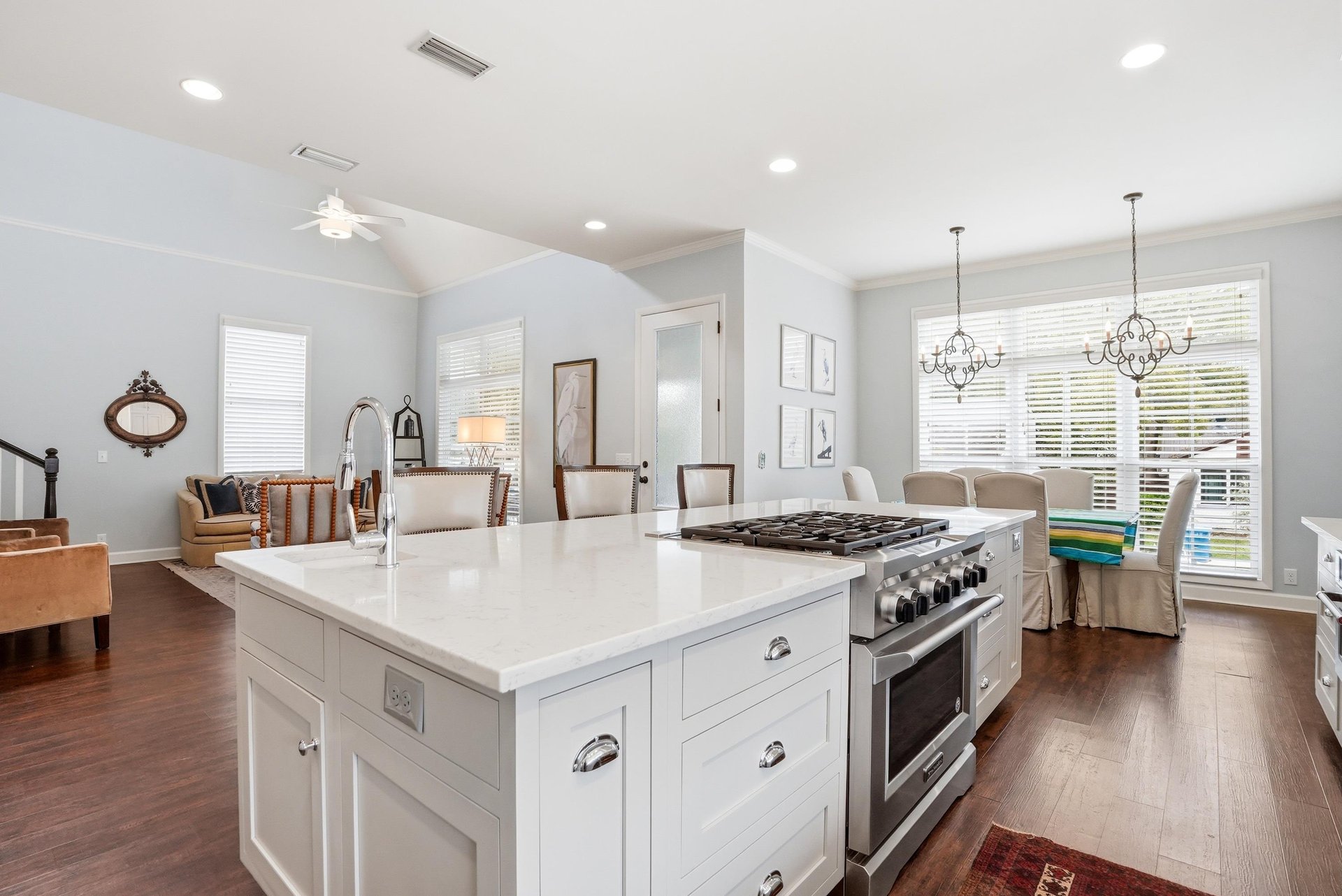 Statement range with a custom hood and open sightlines back to the dining area — no shortcuts in this kitchen.