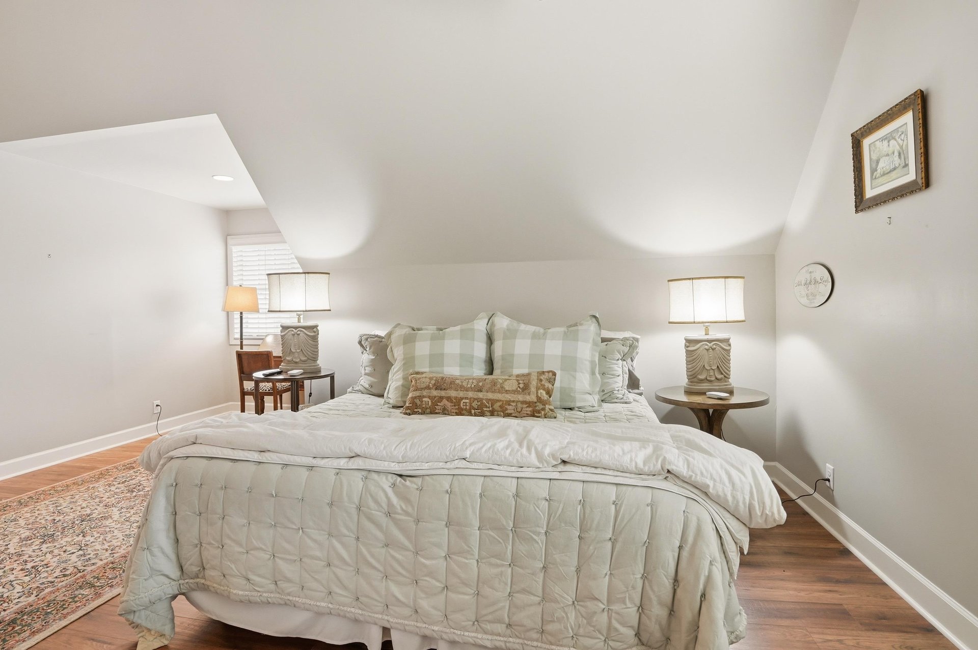 The angled ceiling creates an architectural moment in the primary — spacious and well above the average vacation rental bedroom.