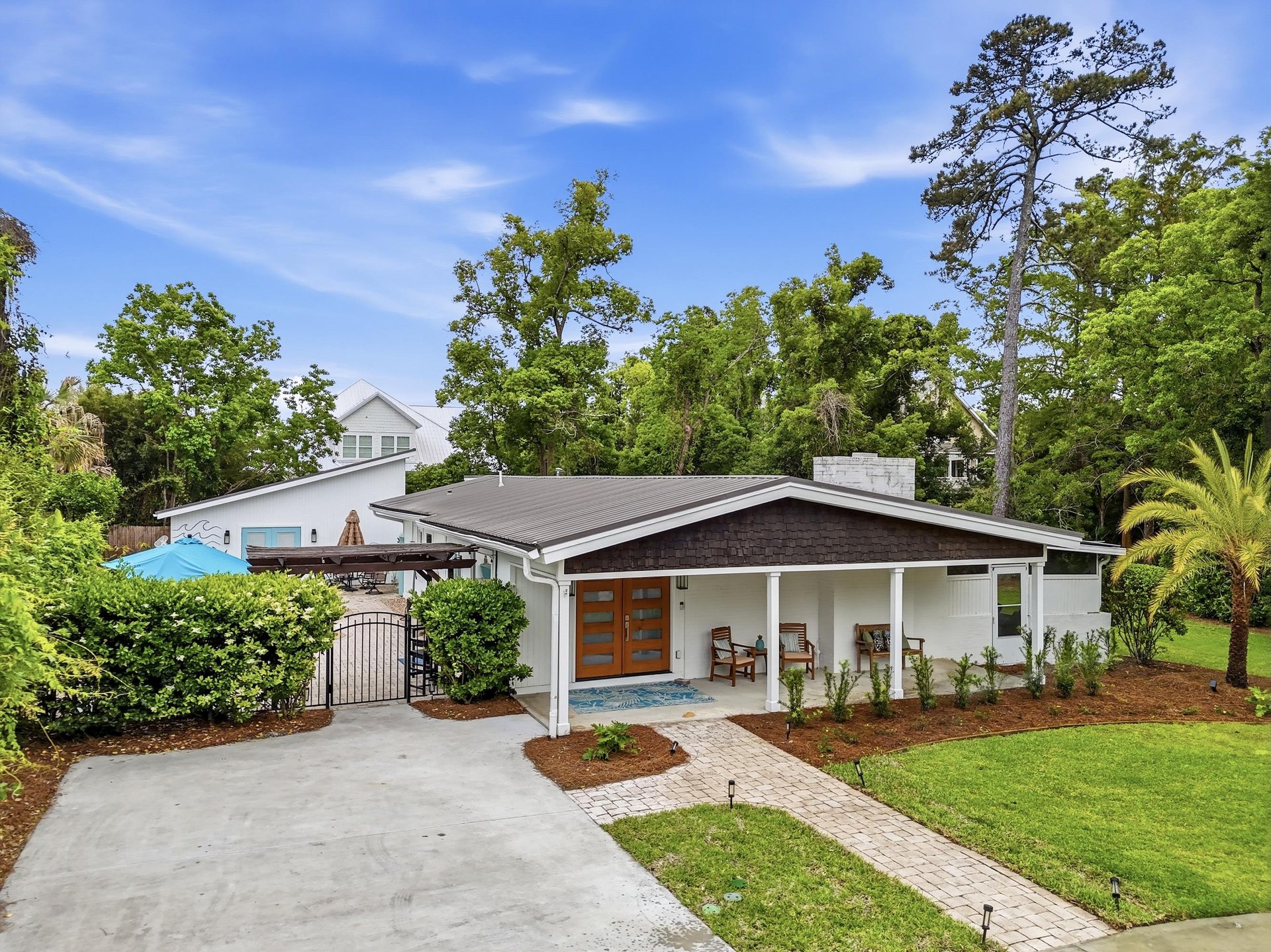 Front exterior view of 530 Delegal showing the covered front porch, driveway, and landscaped yard.