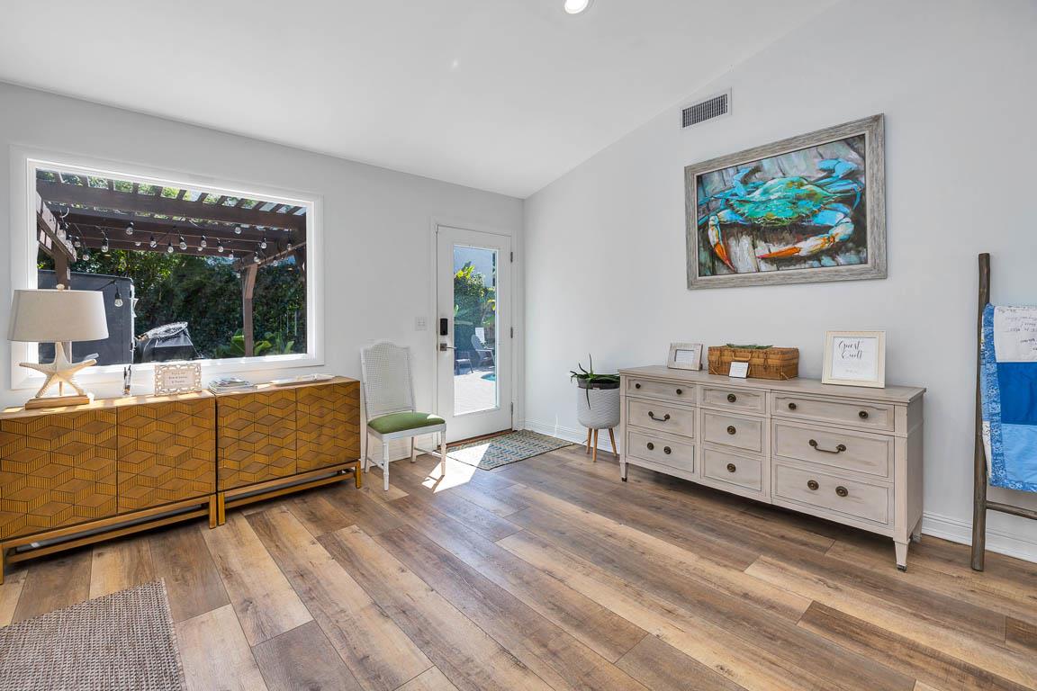 View from the main house living room at 530 Delegal showing interior space with wood flooring and doors opening toward the courtyard.