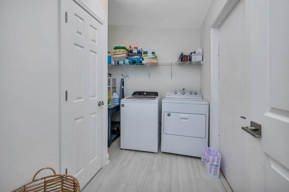 Laundry room at 530 Delegal showing a washer and dryer, shelving for supplies, and enclosed interior space.