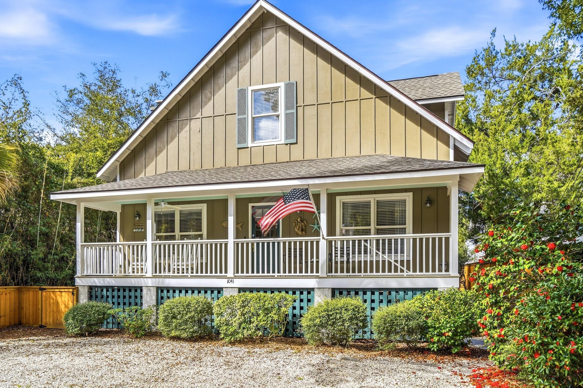 Covered front porch and elevated cottage style set the tone for this King  Prince beach area St. Simons vacation rental.