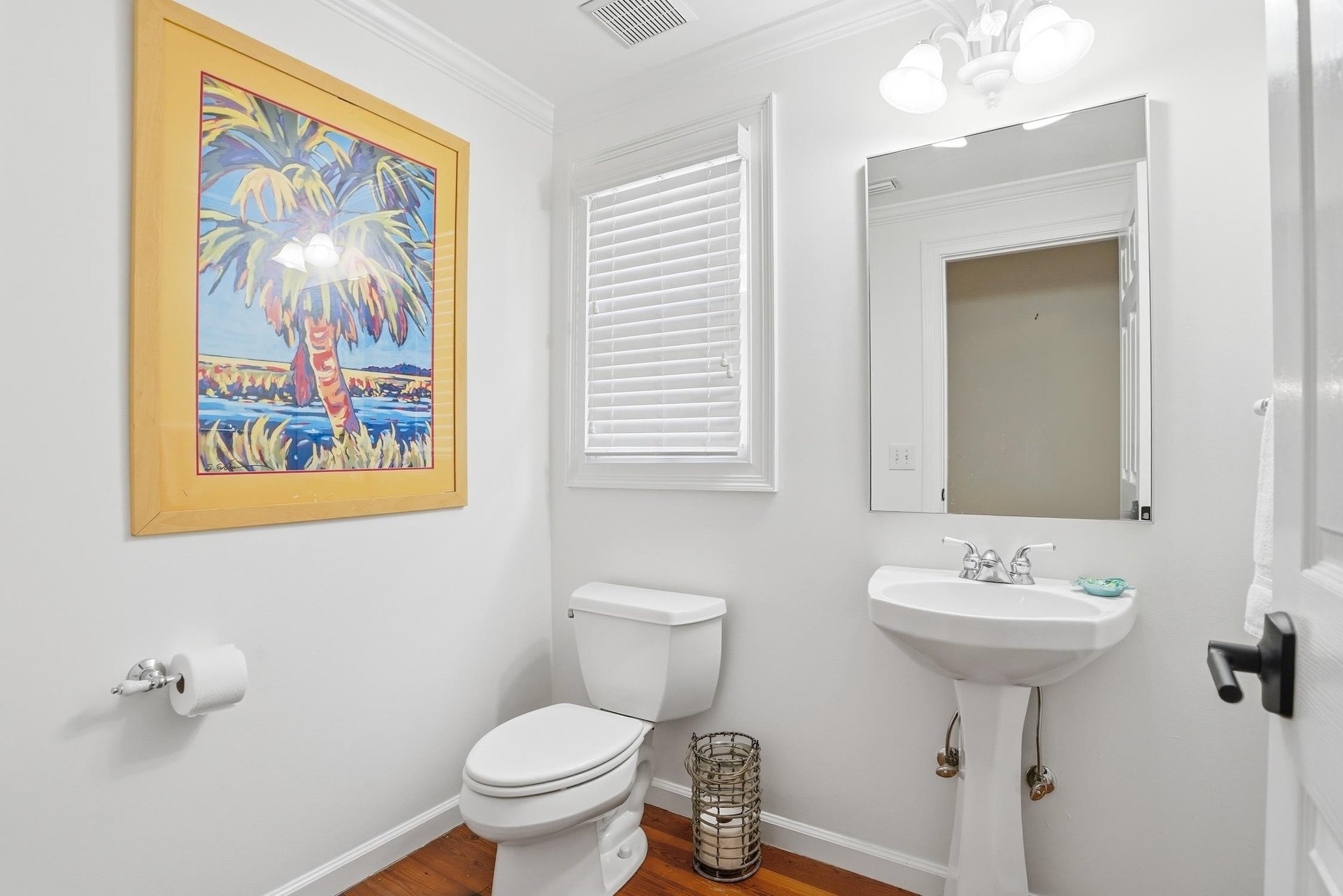 Convenient main level half bath located off the hallway near the shared living spaces.