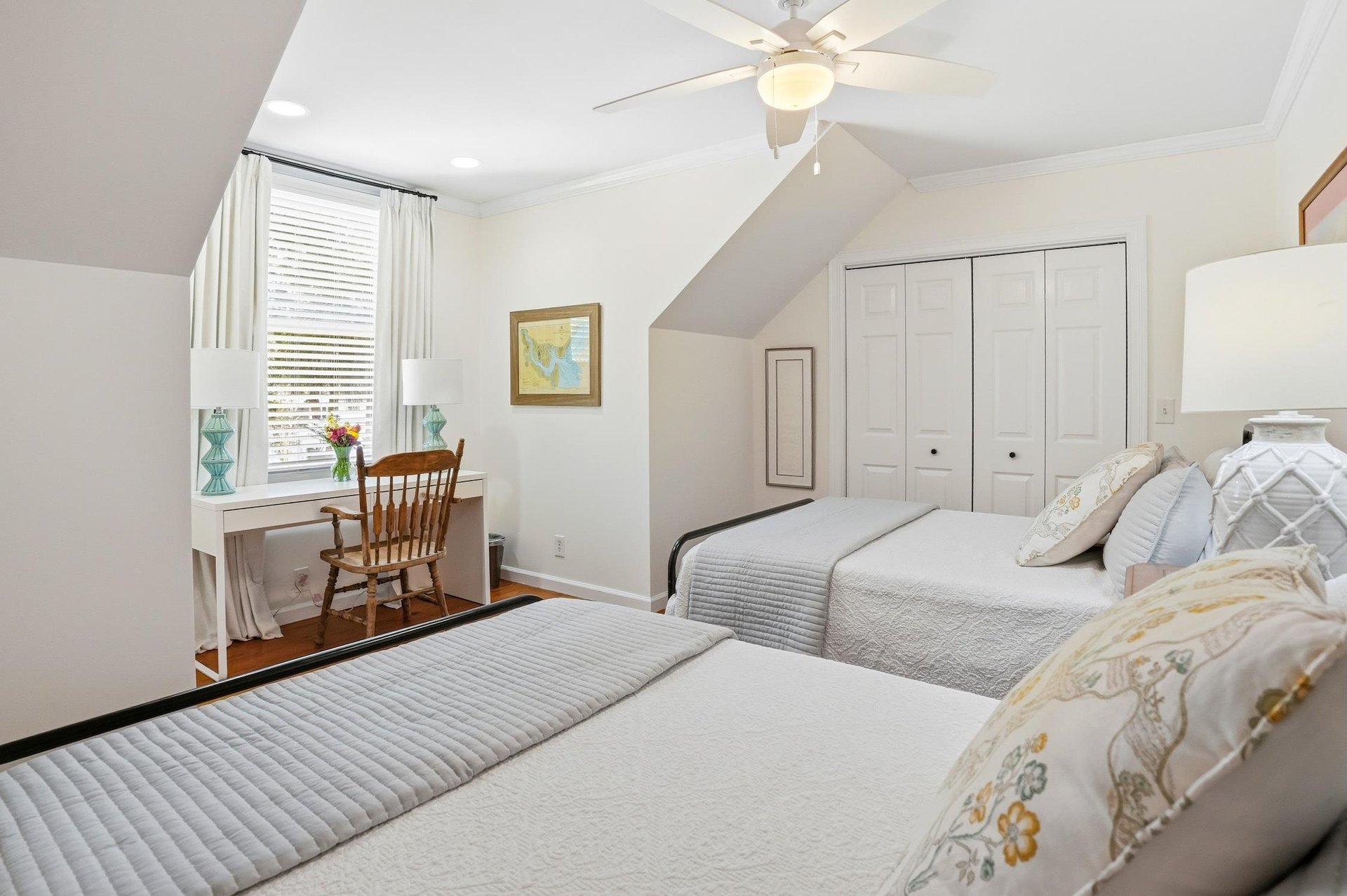 Additional angle of the upstairs twodouble bedroom showing closet storage and the full room layout.
