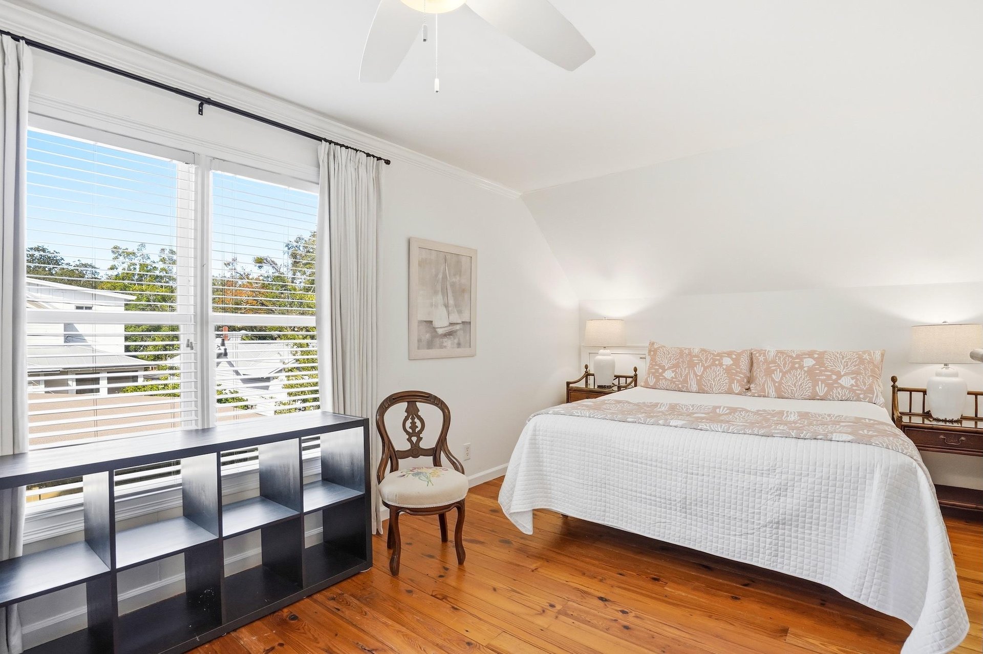 Alternate view of the upstairs kingandtwotwin bedroom with window light and open floor space.